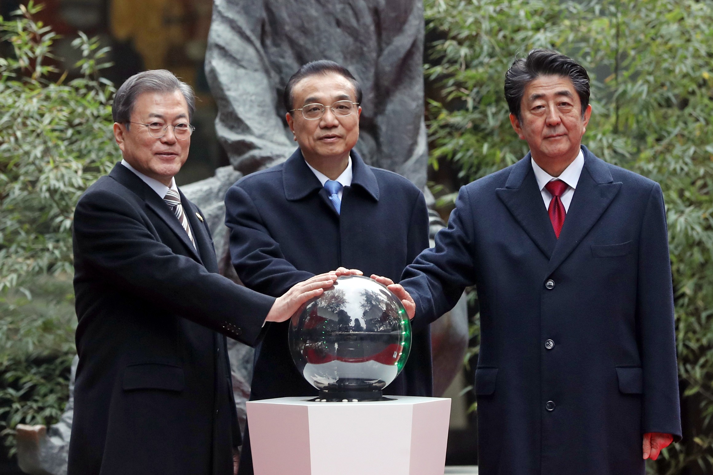 (From left) South Korean President Moon Jae-in, Chinese Premier Li Keqiang and Japanese Prime Minister Shinzo Abe attend a trilateral summit in Chengdu on December 24. Photo: DPA