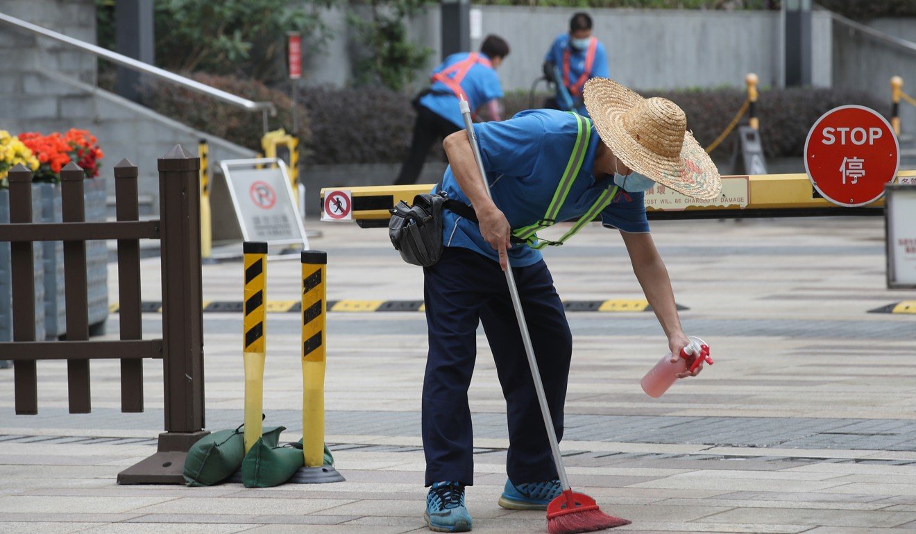 Workers disinfect Oceanaire residence in Ma On Shan, where a person thought to be infected with the Wuhan coronavirus lives. Photo: Winson Wong