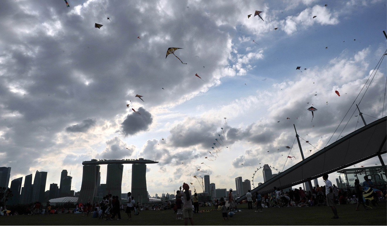People fly kites at Marina Barrage, a rooftop park and dam, in Singapore. Photo: AFP
