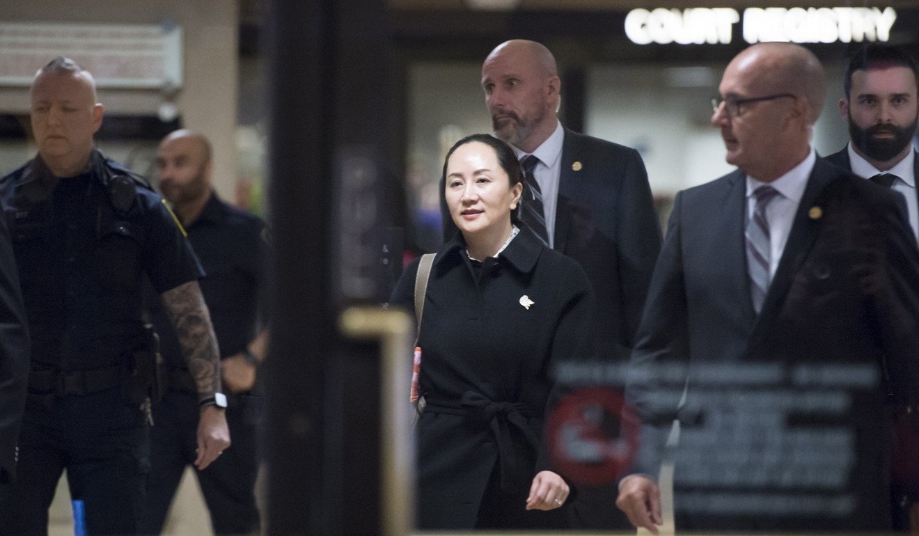 Meng Wanzhou, chief financial officer of Huawei, leaves the British Columbia Supreme Court in Vancouver on Thursday, surrounded by guards. Photo: AP