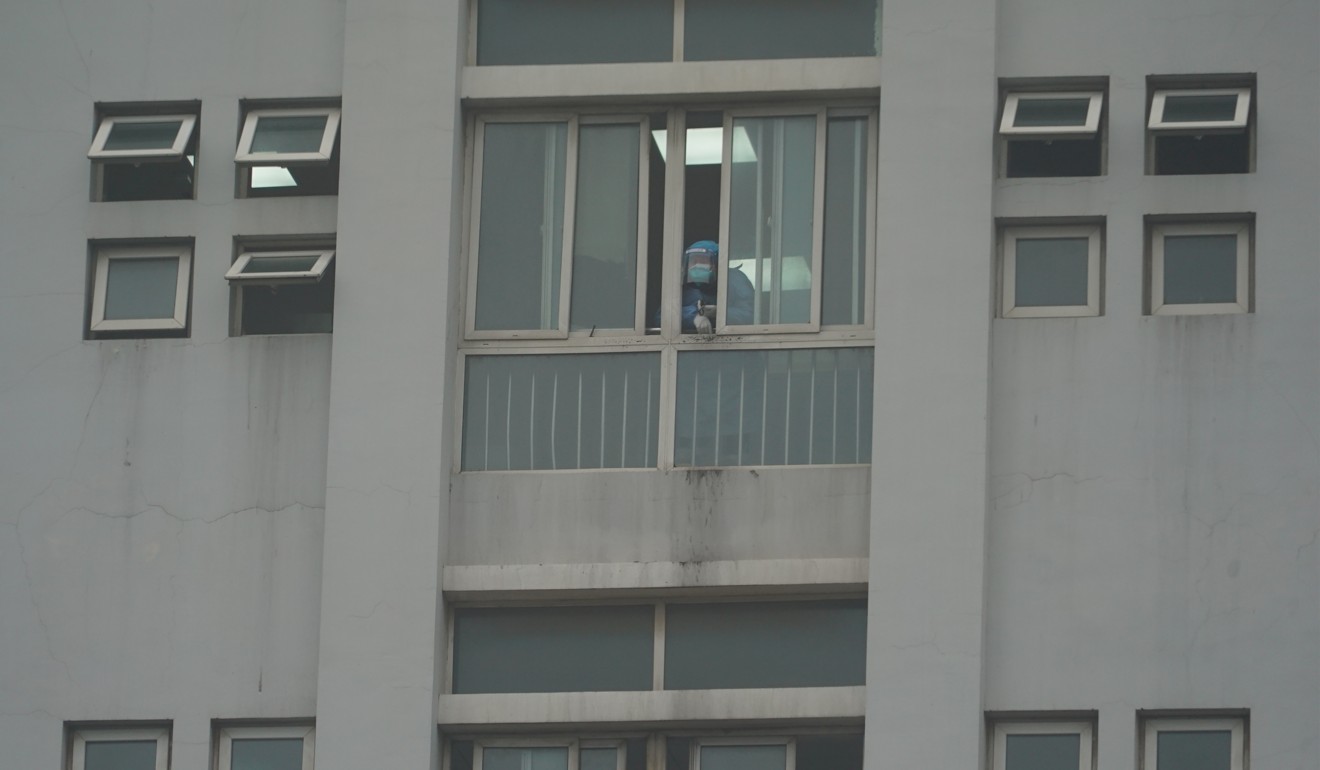 A hospital staff member looks out a window of the Wuhan Medical Treatment Centre. Photo: AP