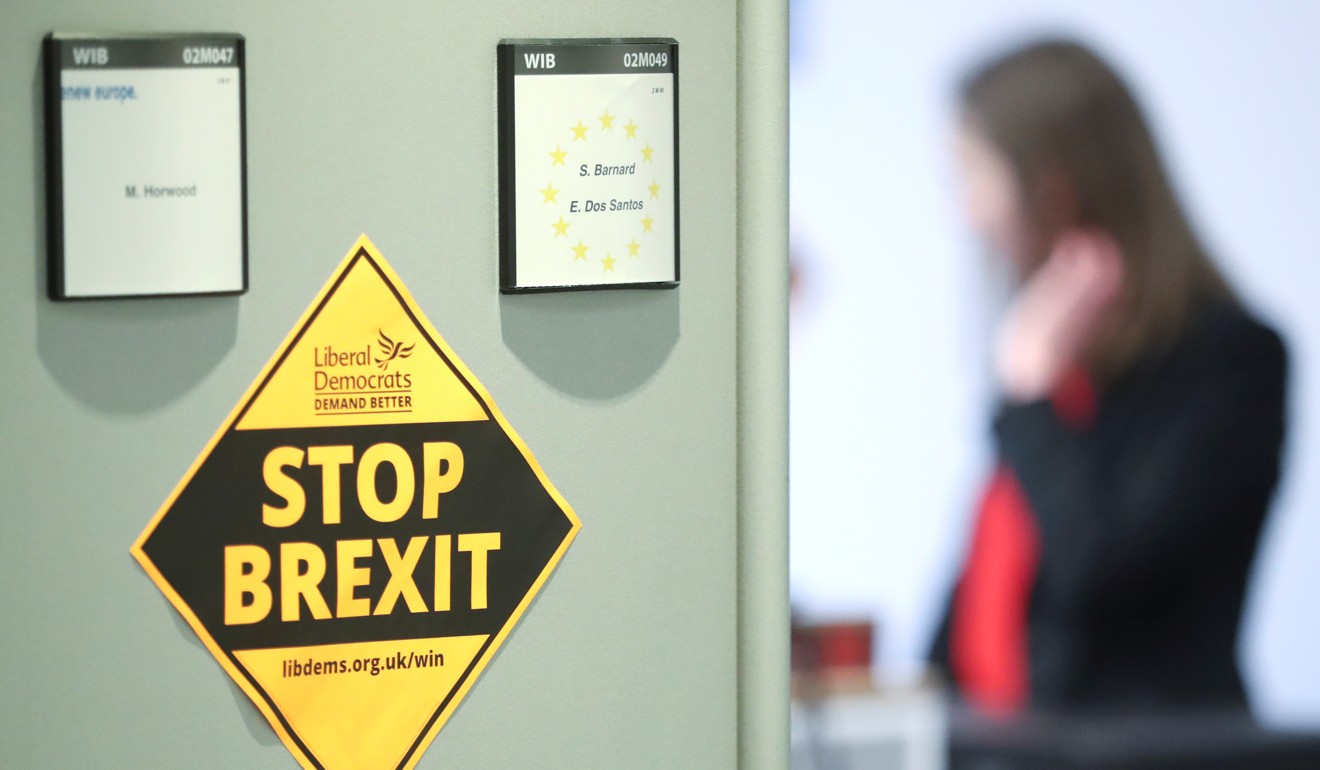 A woman is seen in her office while members of the European Parliament pack their items a week before the Brexit, in Brussels. Photo: Reuters