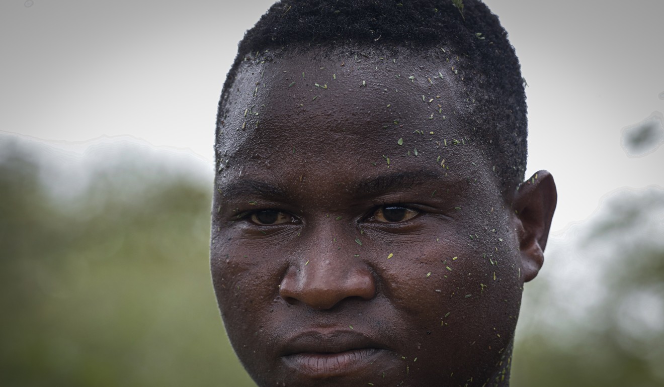 A local farmer who tried to chase away a swarm of desert locusts in the bush near Enziu, Kitui County, in Kenya. Photo: EPA