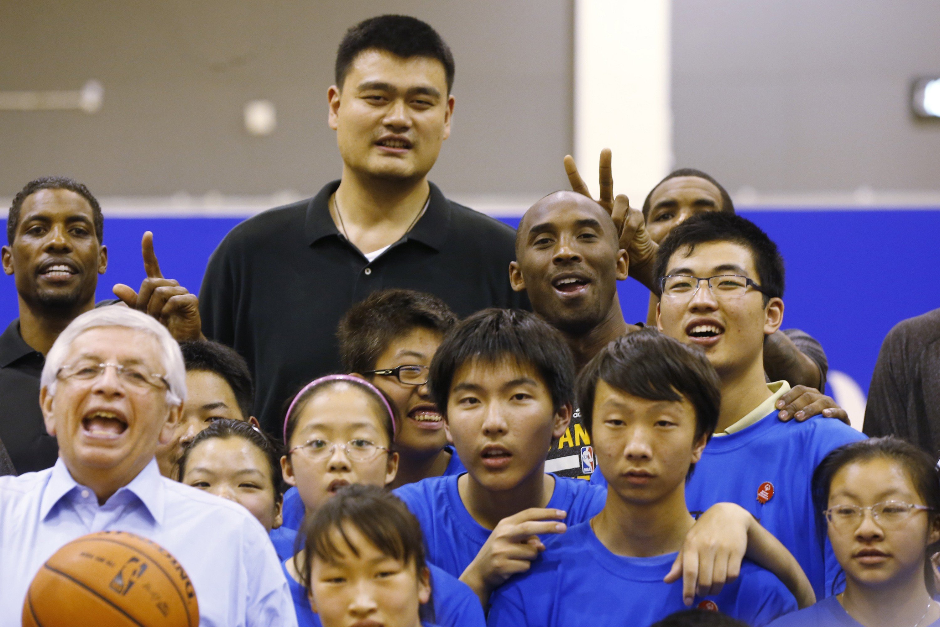 Kobe Bryant, Yao Ming and NBA commissioner David Stern pose with children during the NBA Cares Special Olympics Basketball Clinic in Shanghai in 2013. Photo: AP