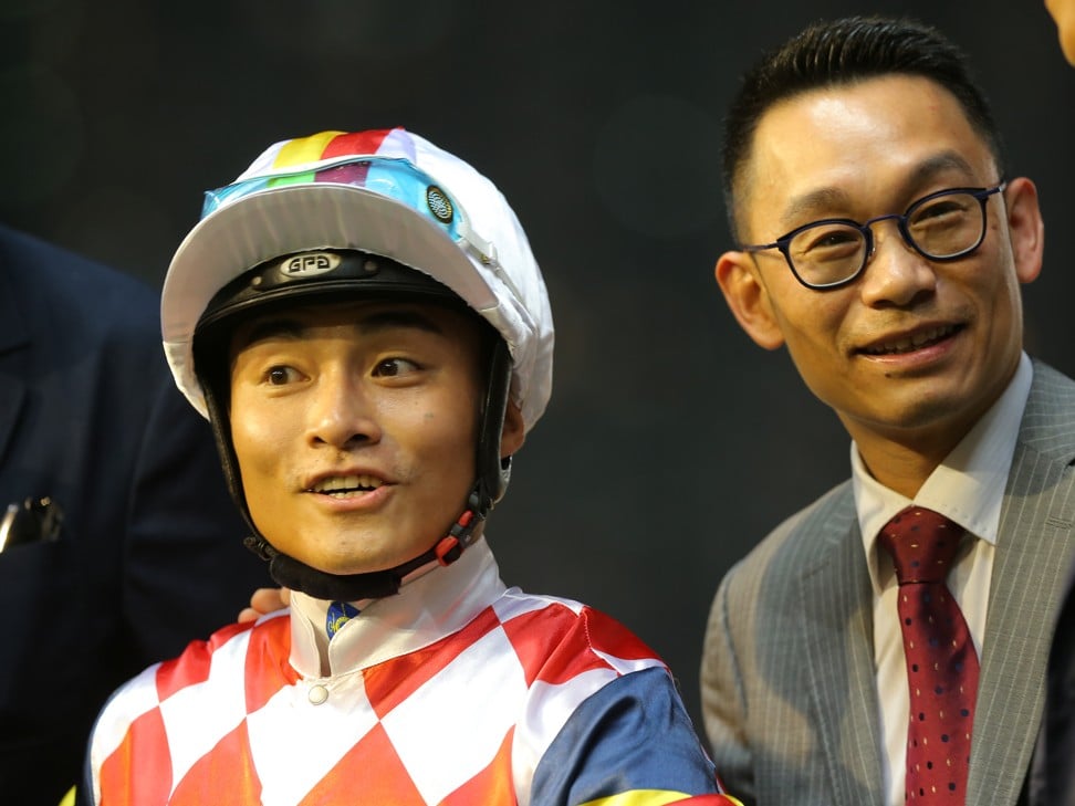 Jockey Keith Yeung (left) and trainer Jimmy Ting celebrate after a Hardly Swears victory.