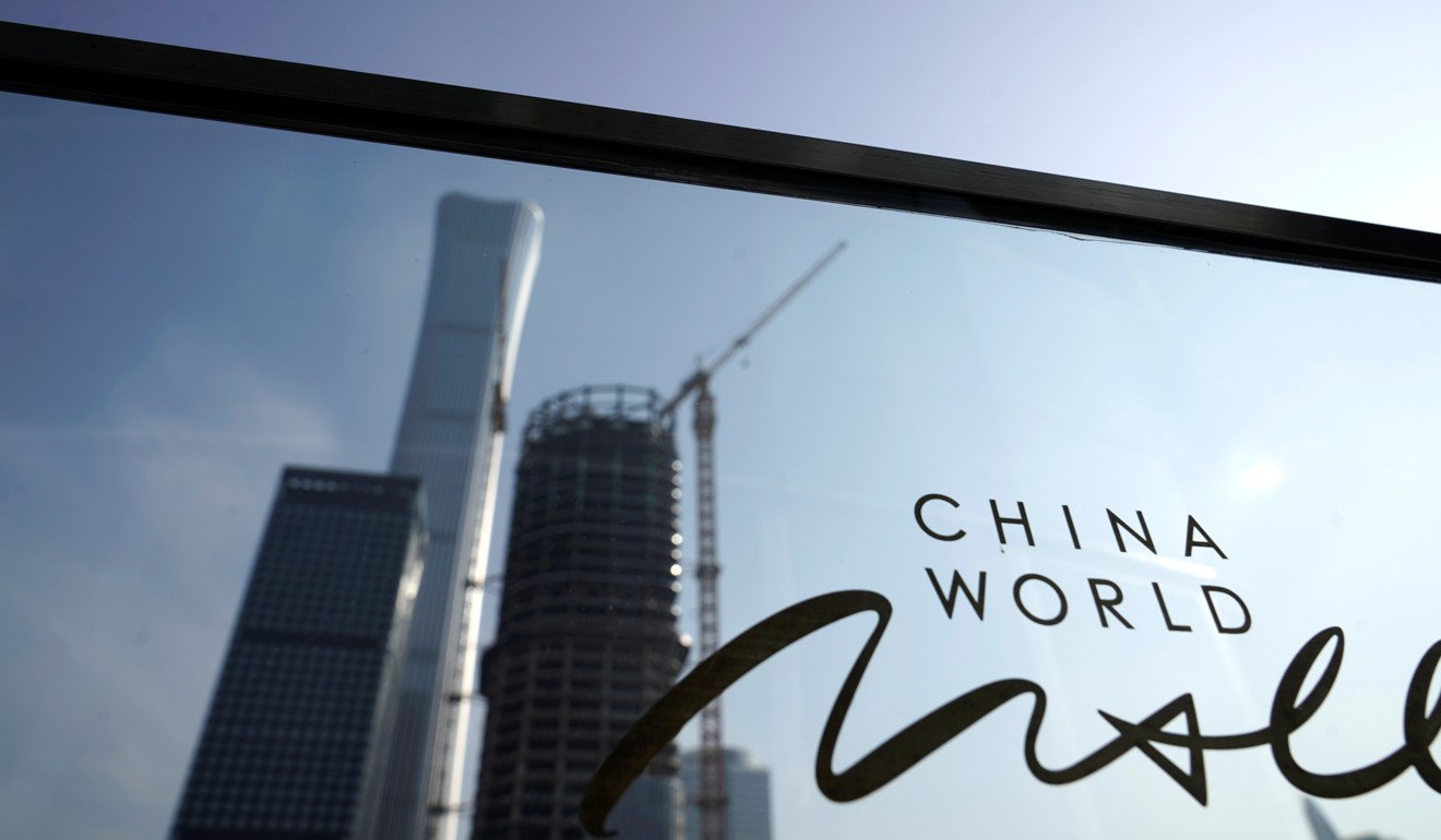 Buildings in Beijing’s central business are reflected in a window. China is often quoted as having one of the highest private-sector debt to GDP ratios in the world. But the comparison rarely takes into account the differing ways debt levels are calculated in China when compared with other nations. Photo: Reuters