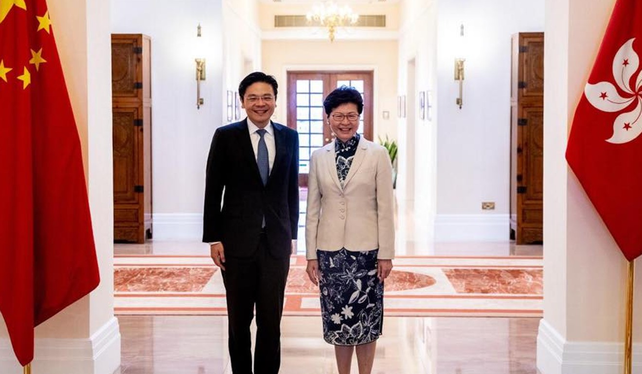 Singapore’s National Development Minister Lawrence Wong, pictured with Hong Kong Chief Executive Carrie Lam, has cautioned his countrymen against ‘turning xenophobic’. File photo