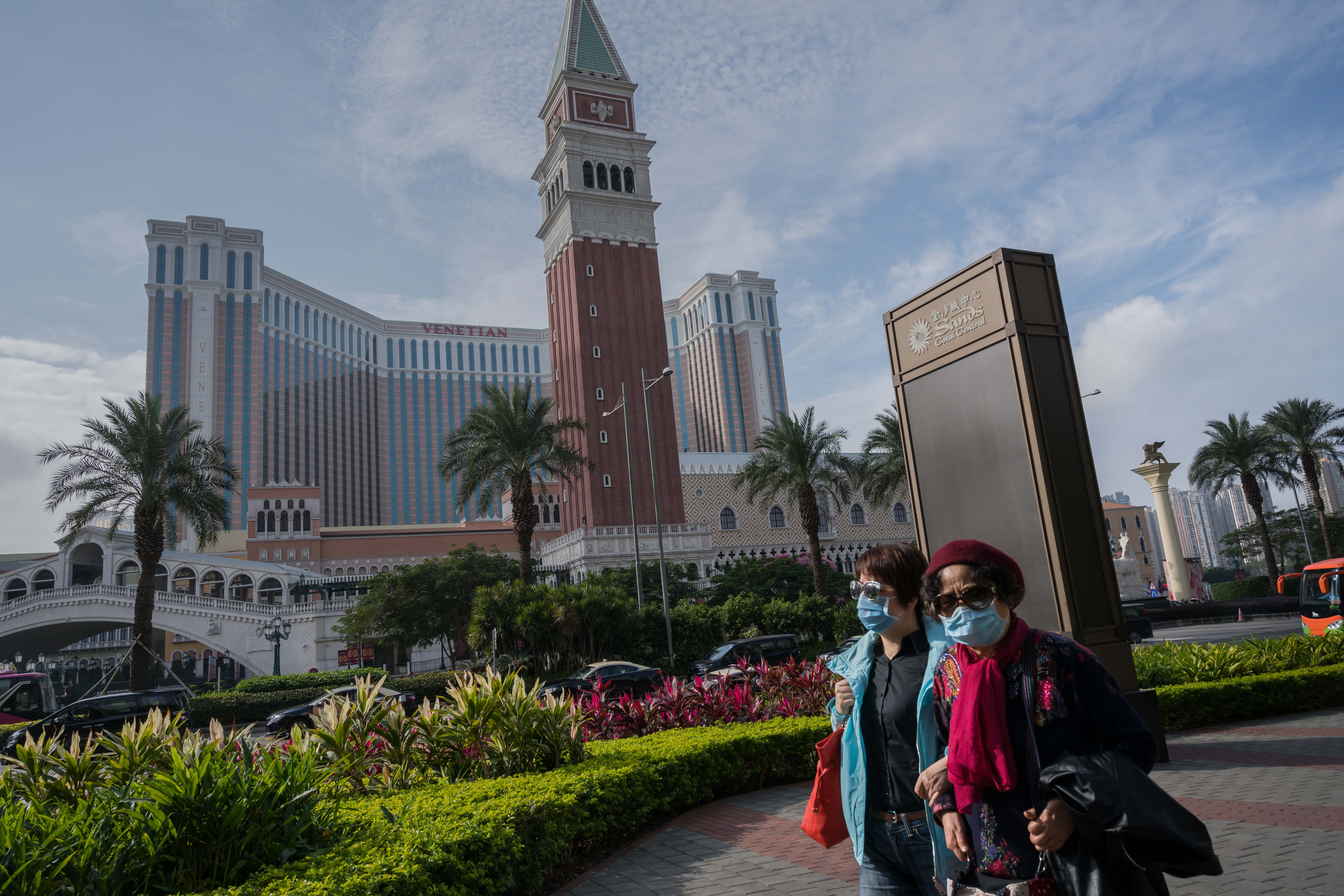 Pedestrians in protective medical masks walk past the Sands Cotai Central and Venetian Macao casino resorts, operated by Sands China, in Macau on January 24, 2020. Photo: Bloomberg