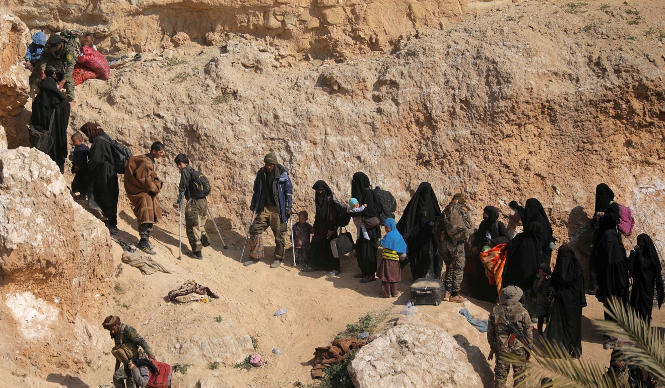 Islamic State fighters and their families after surrendering in Baghouz, Syria. Photo: Reuters