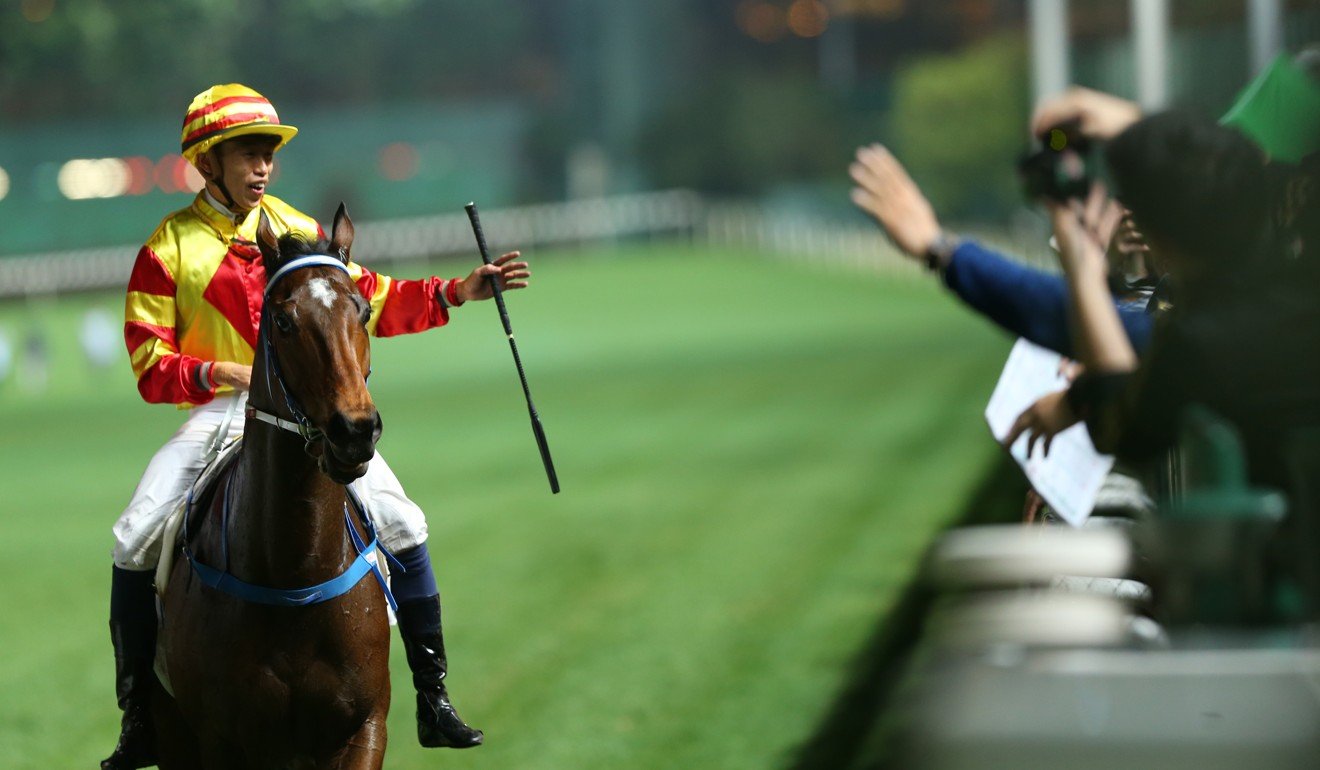 Vincent Ho salutes to the crowd after riding a winner at Happy Valley.
