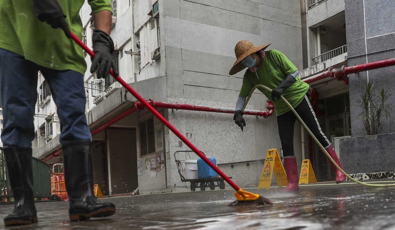 Cleaners wash the floor at Yau Oi Estate in Tuen Mun. Photo: Sam Tsang