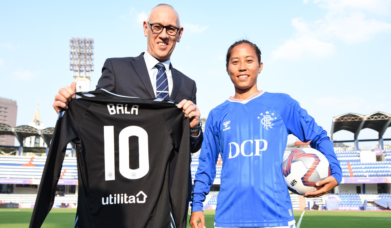 Devi (right) with Rangers FC ambassador Mark Hateley after signing on an 18-month deal. Photo: Handout