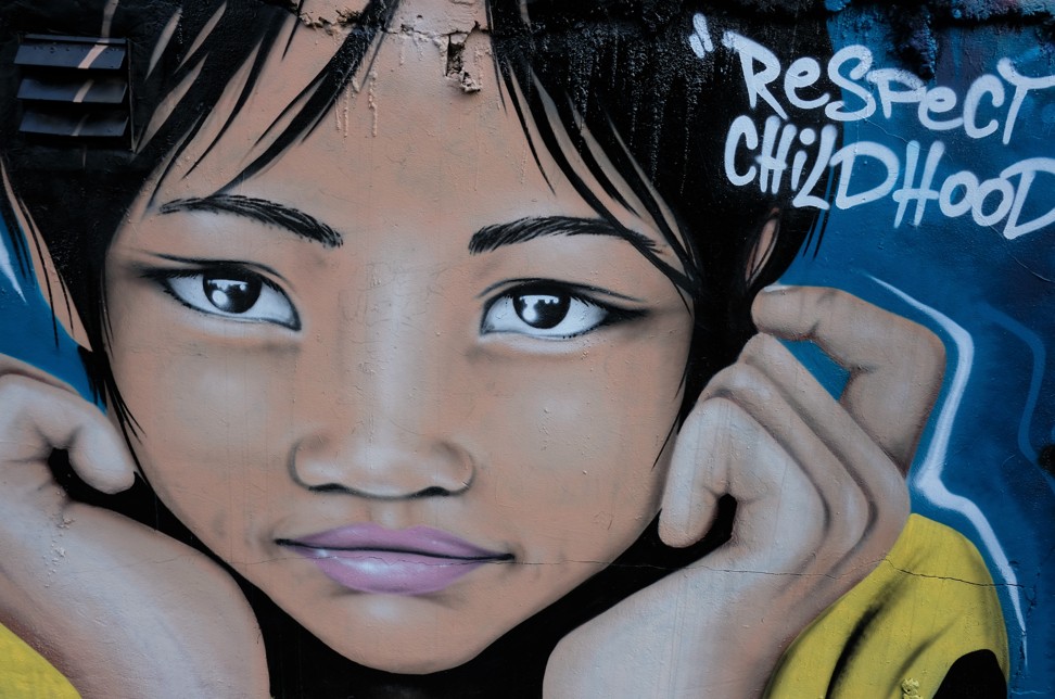A mural by a street artist on a wall beside an inner-city slum in Bangkok, Thailand. Photo: Tibor Krausz
