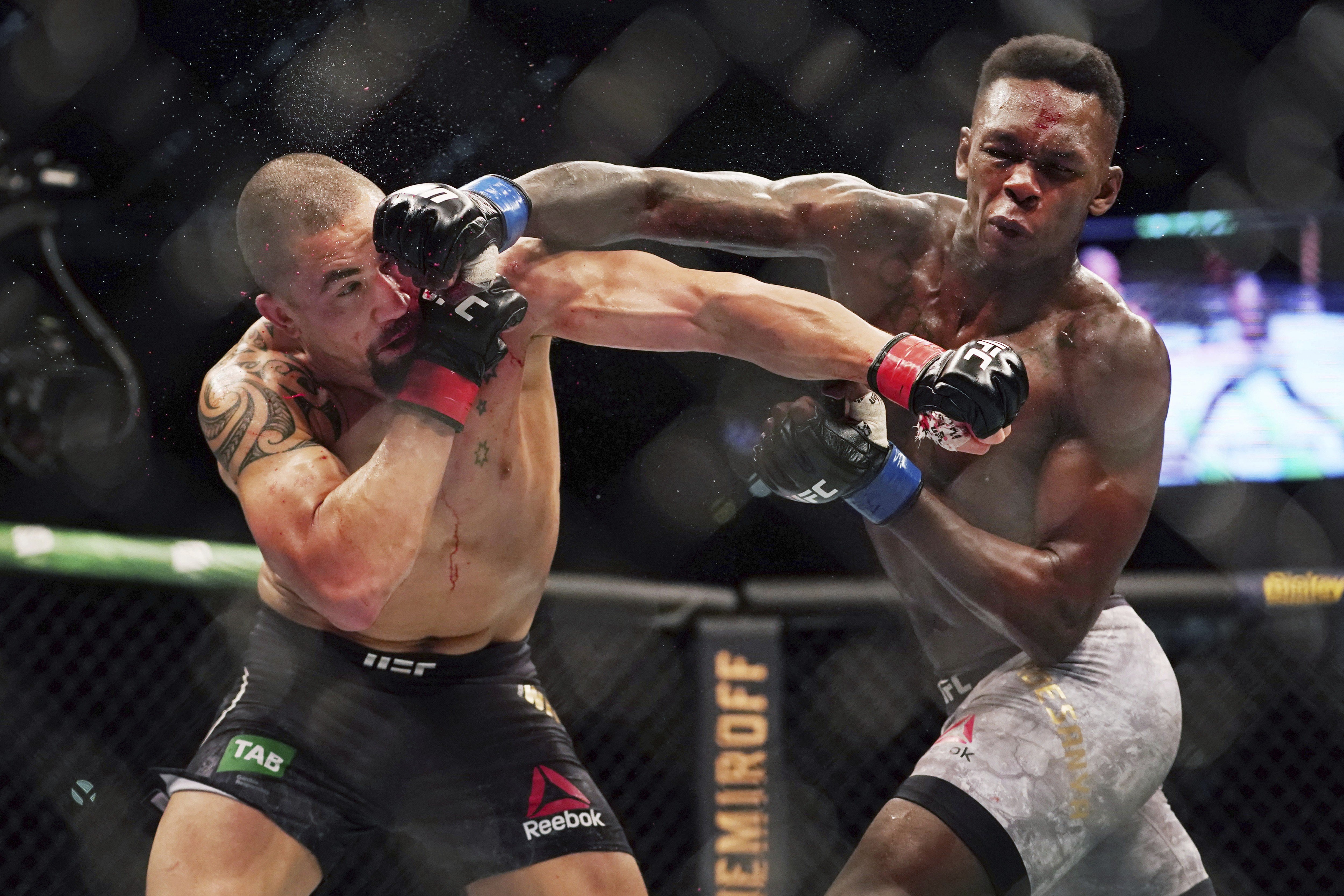 Israel Adesanya (right) throws a right straight at former champion Robert Whittaker at their UFC 243 middleweight unification fight in October last year. Photo: AP