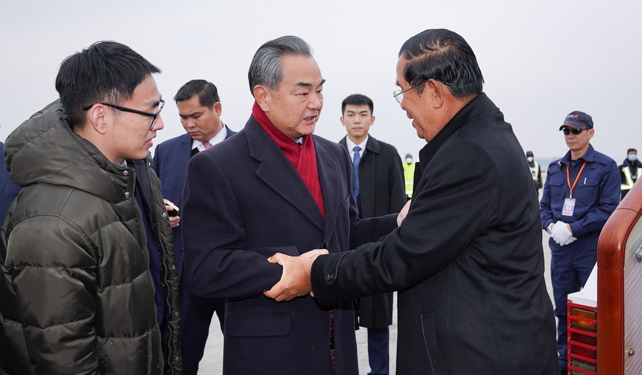Chinese Foreign Minister Wang Yi (centre) welcomes Cambodian Prime Minister Hun Sen on his arrival in Beijing on Wednesday. Photo: Xinhua