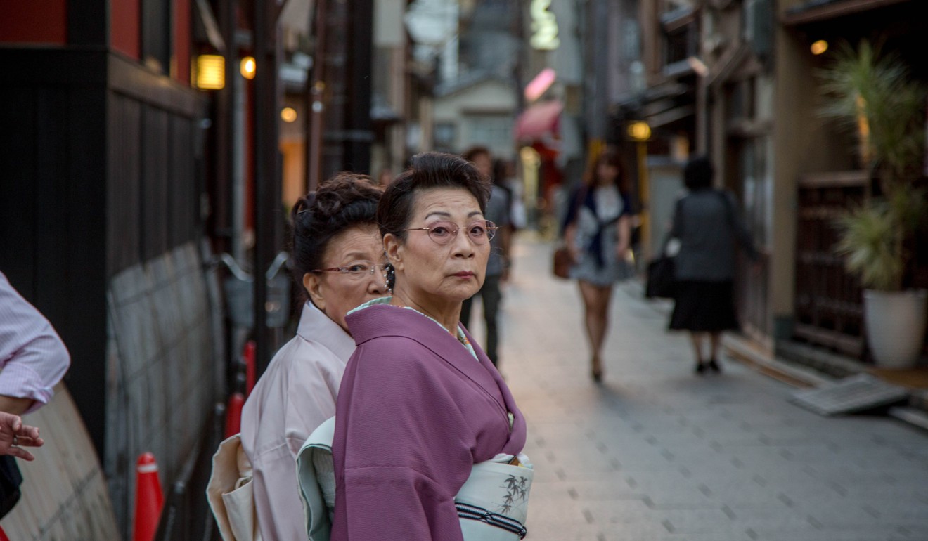Two elderly women in a traditional alley of Tokyo. Japan is raising the retirement age to 70. Photo: Getty Images