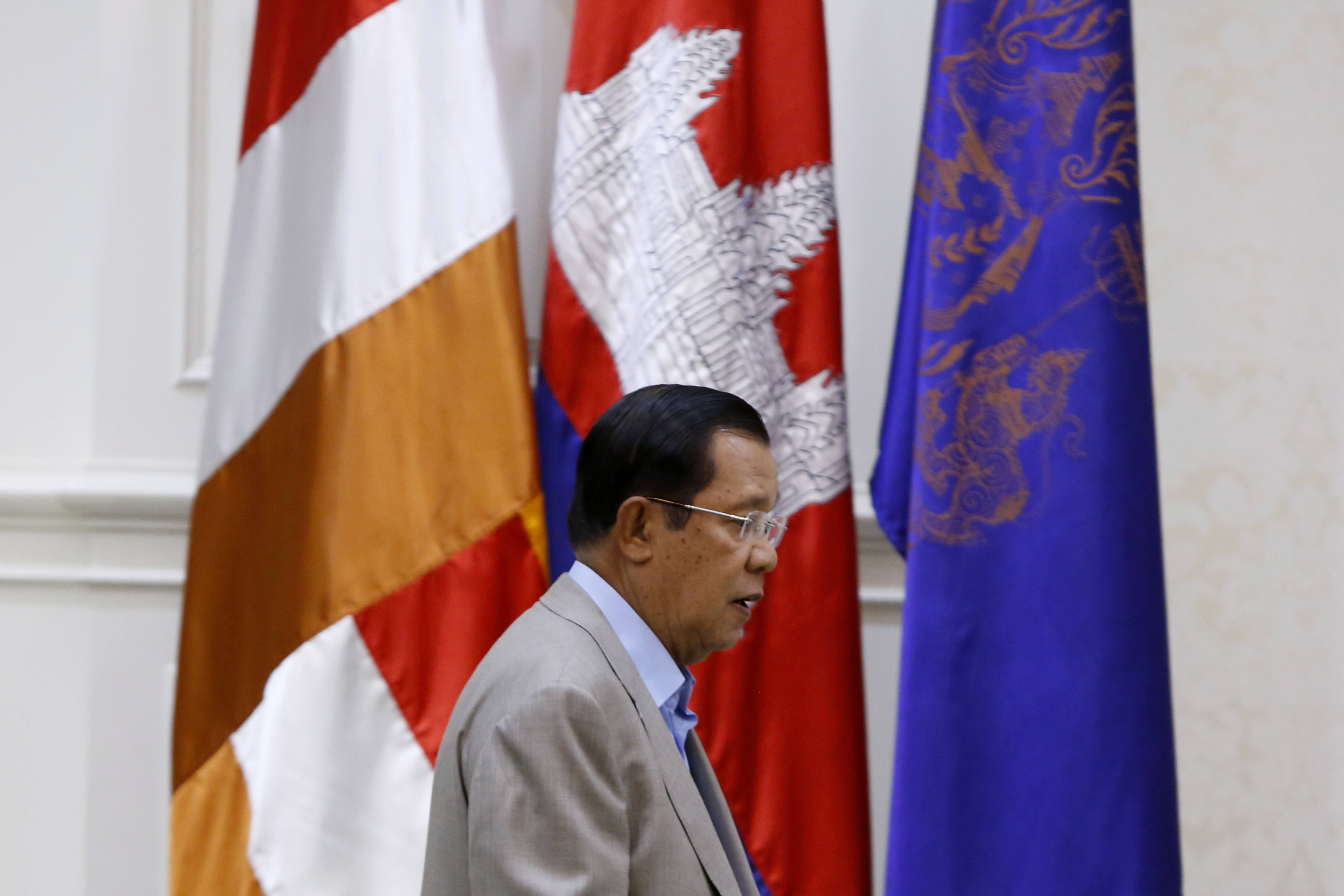 Cambodian Prime Minister Hun Sen arrives in a room to hold a press conference on prevention measures against coronavirus. Photo: EPA