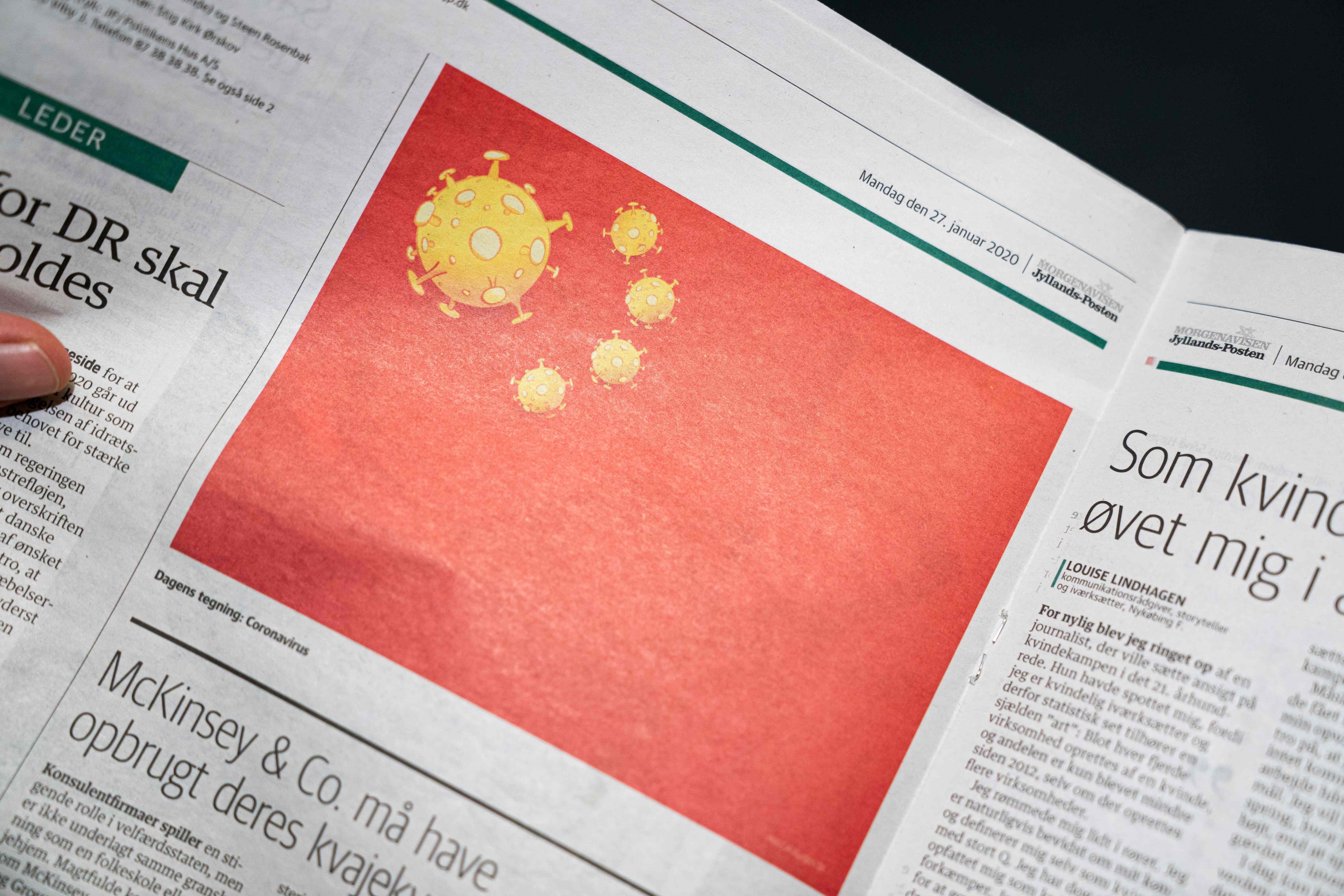 The Danish daily Jyllands-Posten has come in for criticism after it published on January 27 a satirical cartoon by Niels Bo Bojesen, who replaced the stars on the Chinese flag with the coronavirus. Photo: AFP
