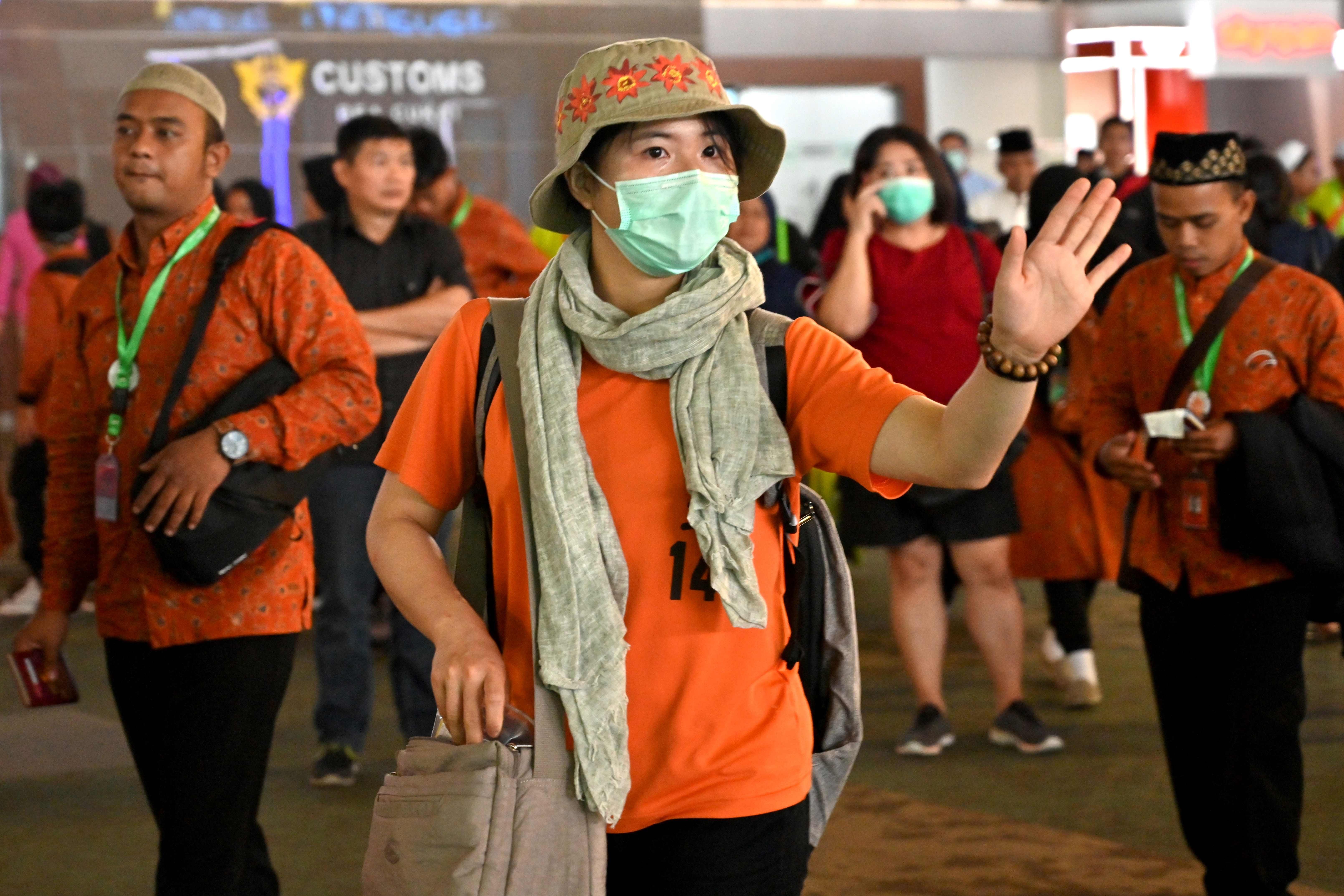 A passenger wearing a face mask walks through Sukarno-Hatta international airport in Indonesia’s Tangerang on Wednesday. Photo: AFP
