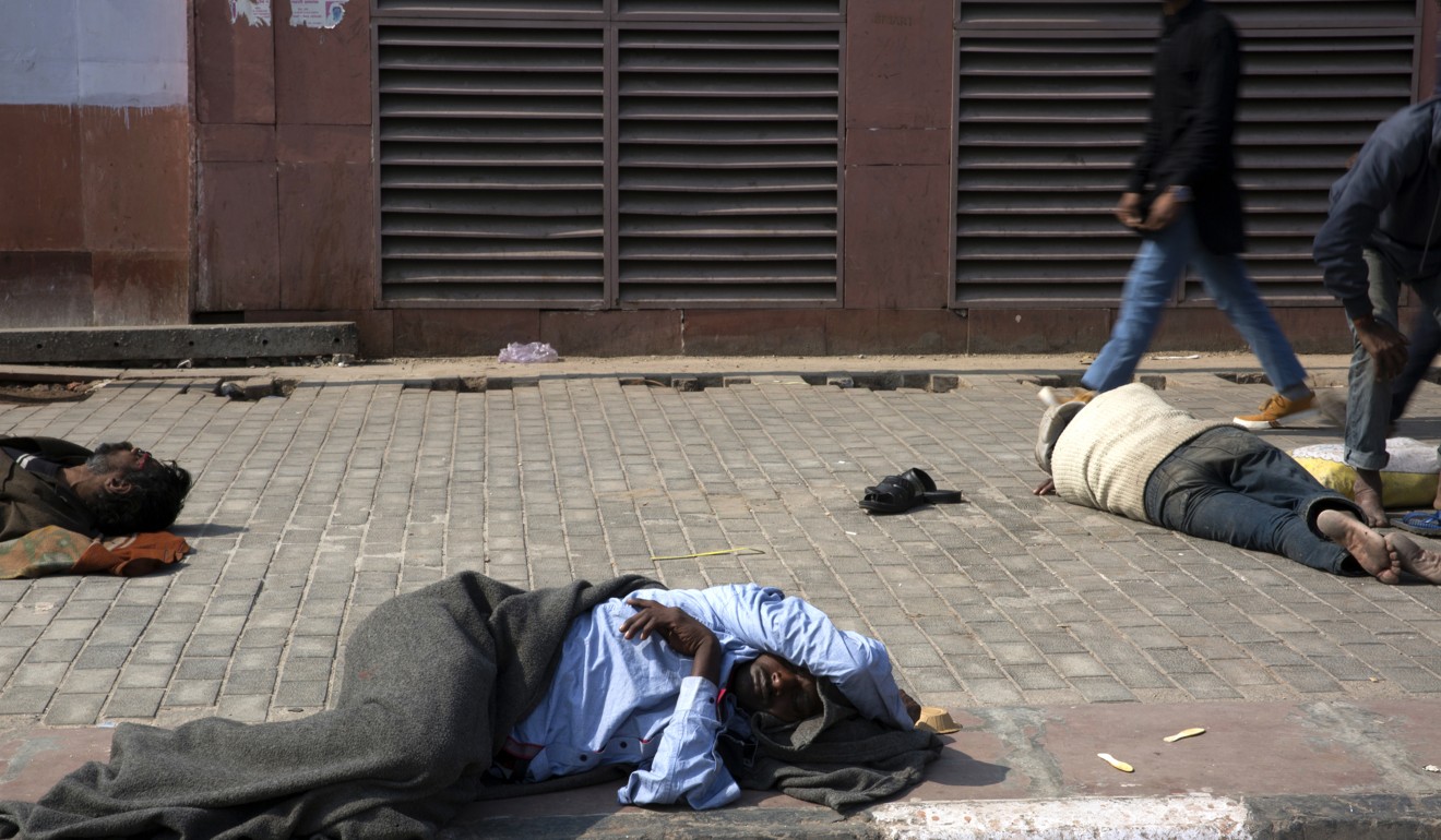 Homeless people sleep on a pavement in New Delhi. India’s budget has been criticised for focusing on wealth creation instead of job creation. Photo: Bloomberg
