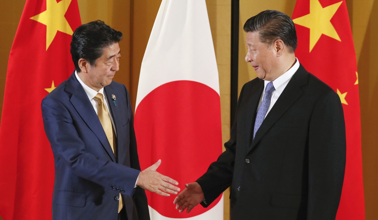 Japanese Prime Minister Shinzo Abe (left) and Chinese President Xi Jinping meet for talks in Osaka last year. Xi is expected to travel to Japan in early April. Photo: EPA-EFE