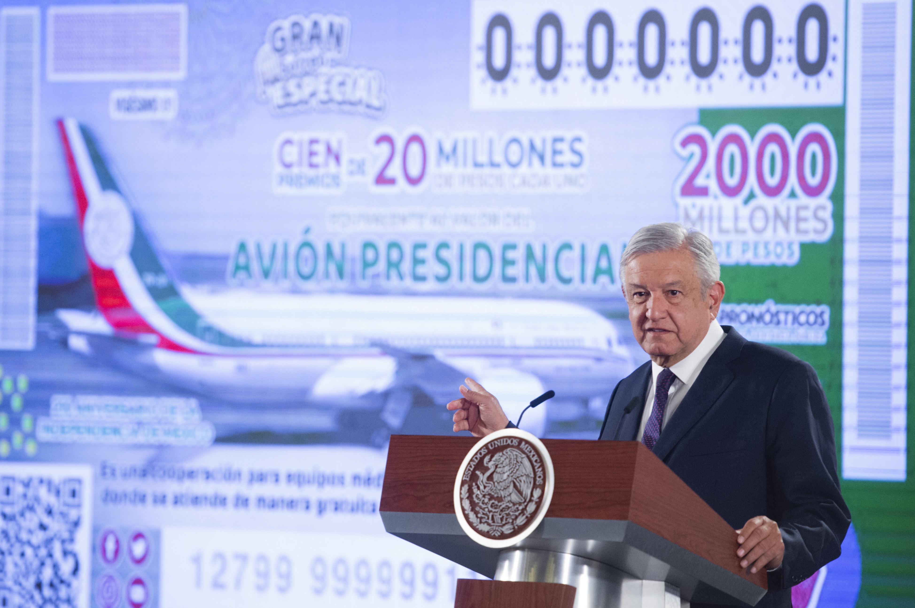 Mexico’s President Andres Manuel Lopez Obrador stands in front of an image of a raffle ticket featuring the presidential plane at the National Palace in Mexico City on Friday. Photo: Mexico's Presidential Press Office via AP
