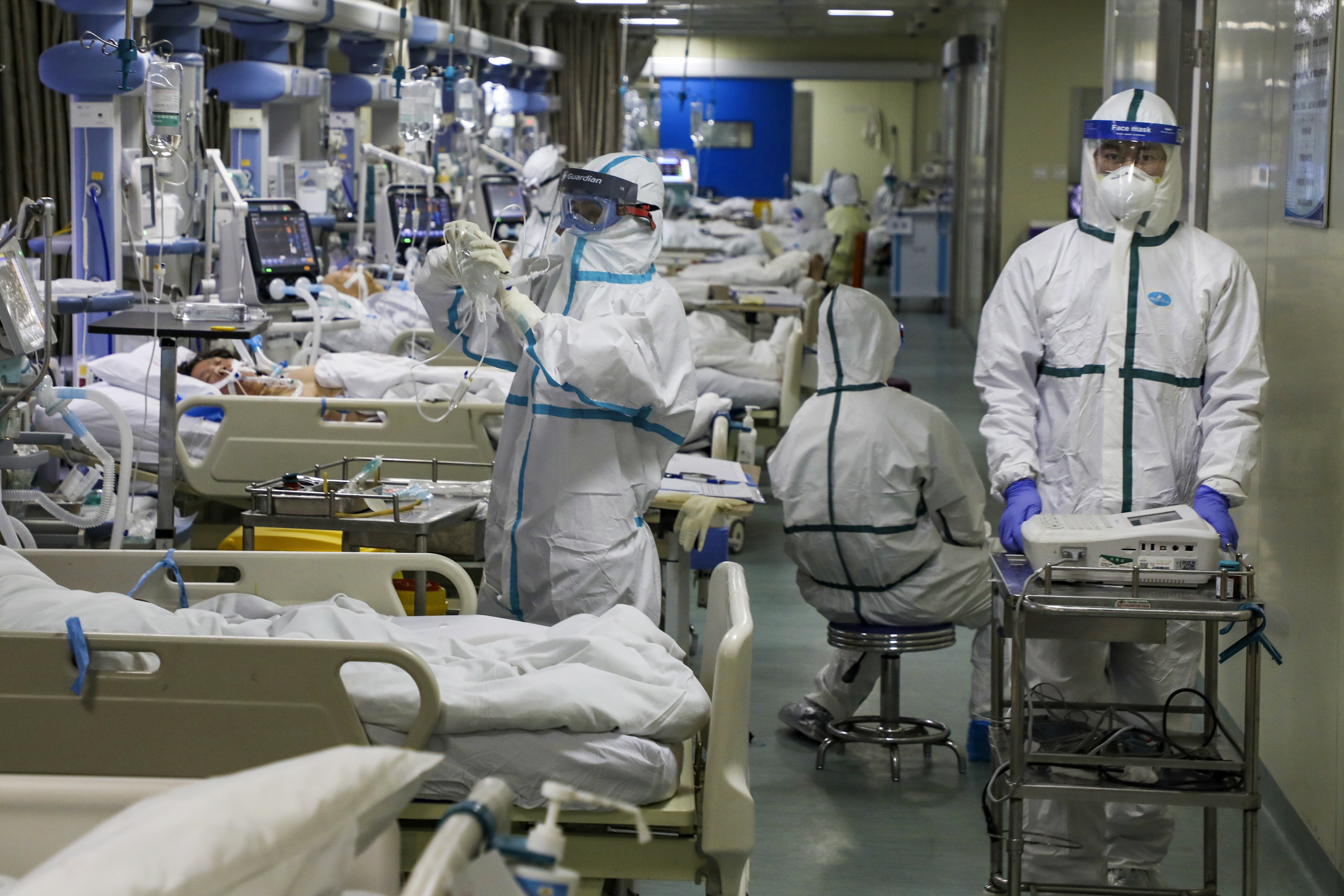 Medical workers treat patients in an isolated intensive care unit at a hospital in Wuhan. Photo: Chinatopix via AP