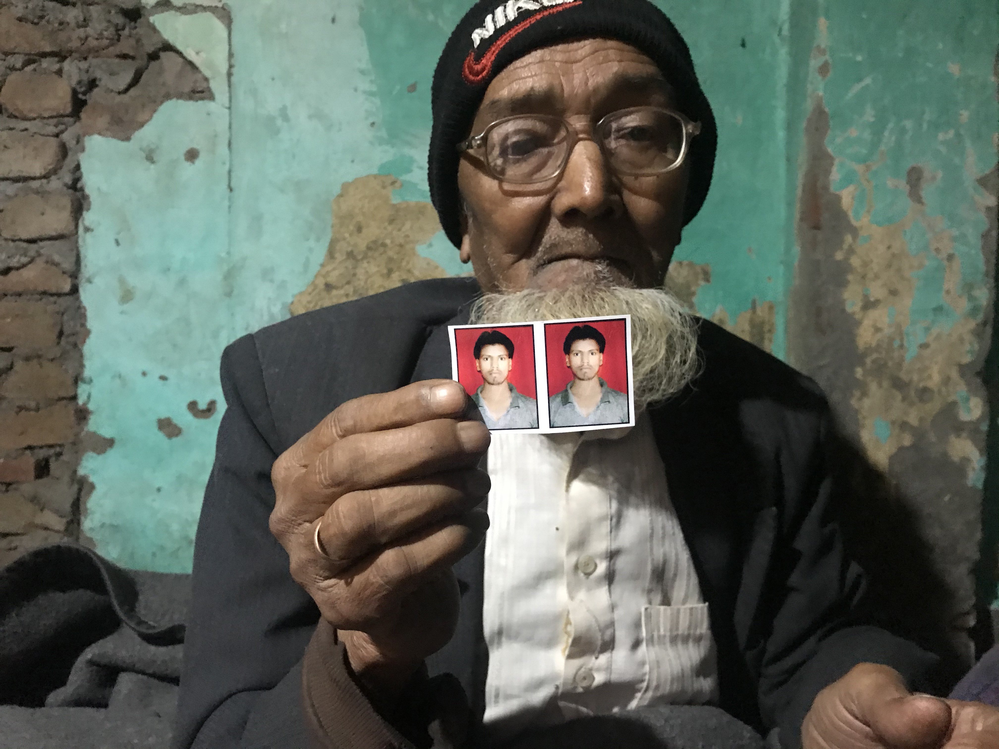 Aleem Ansari’s 85-year-old father, Habib, holds a photo of his slain son. Photo: Ashish Malhotra