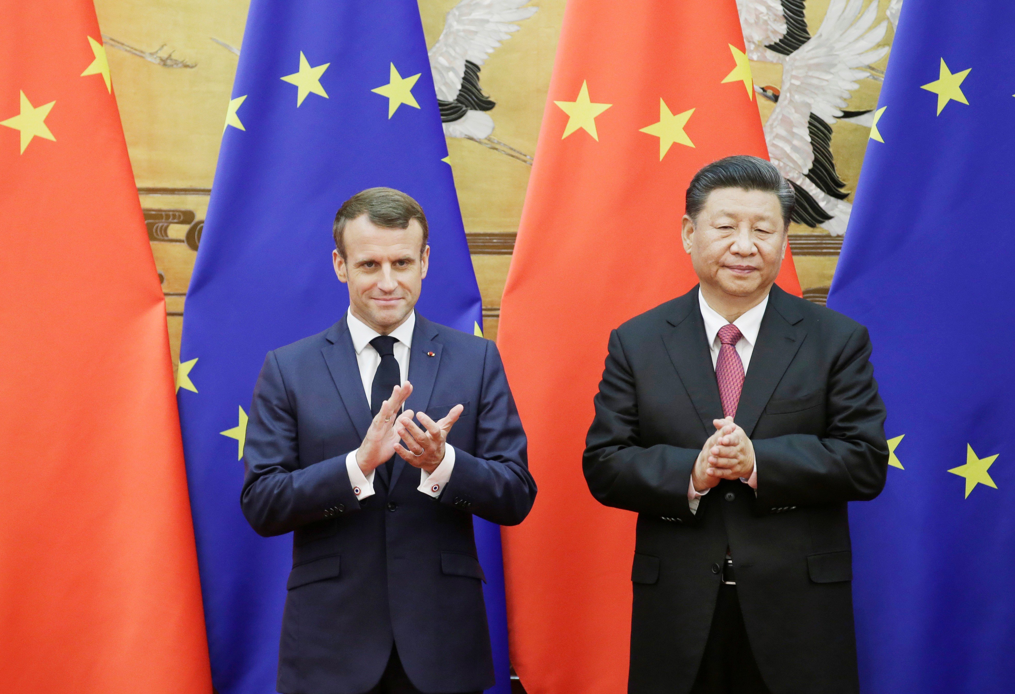 Chinese President Xi Jinping and French President Emmanuel Macron stand in front of Chinese and European Union flags at a signing ceremony in the Great Hall of the People in Beijing on November 6, 2019. Photo: Reuters