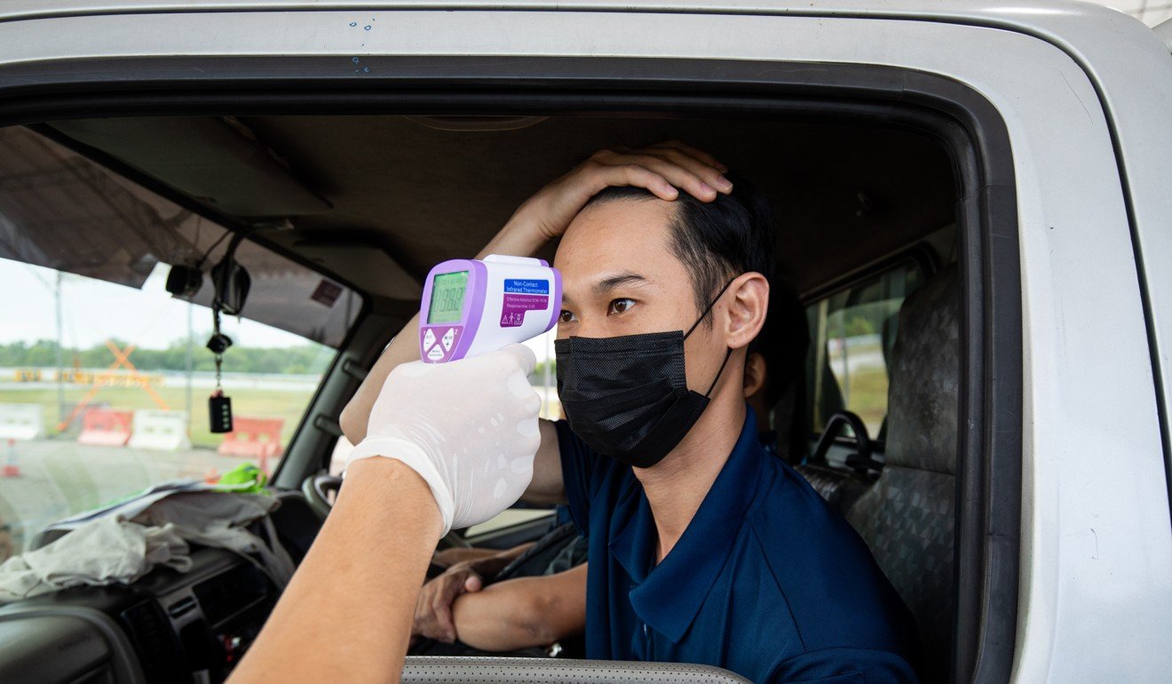 An attendee at the Singapore Airshow is screened by a medic. Photo: Bloomberg