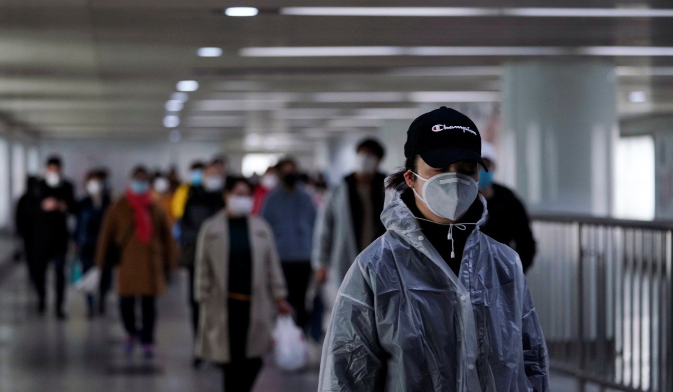 People wear face masks walk in an underpass in Shanghai on Monday. Photo: Reuters