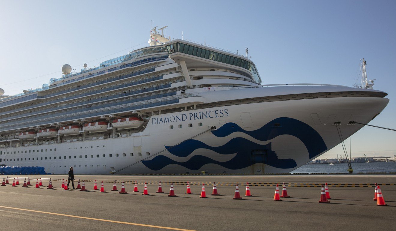 A reporter walks near the quarantined Diamond Princess cruise ship in Yokohama, near Tokyo. Photo: AP