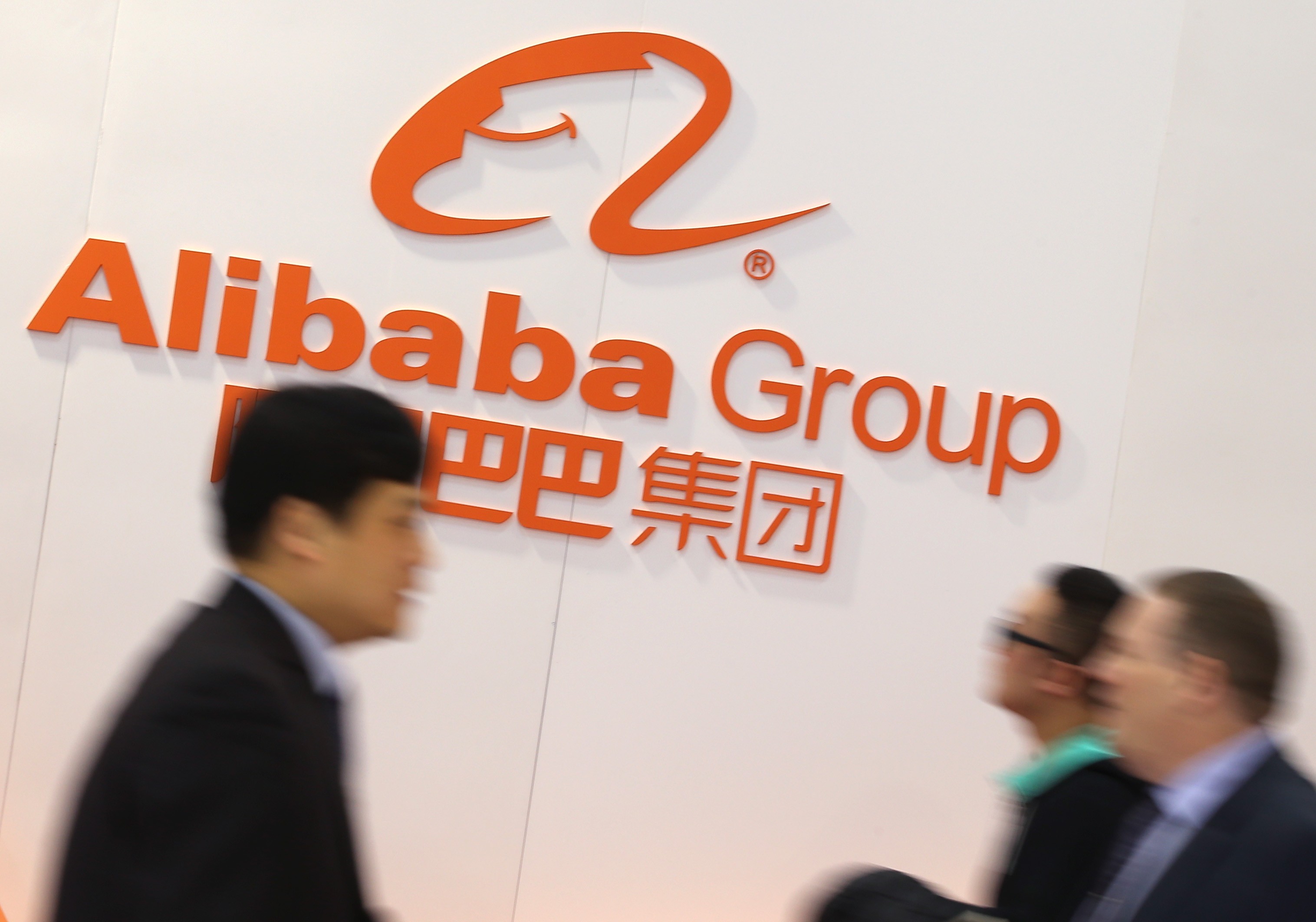 People pass by the logo of e-commerce giant Alibaba Group Holding. Photo: dpa