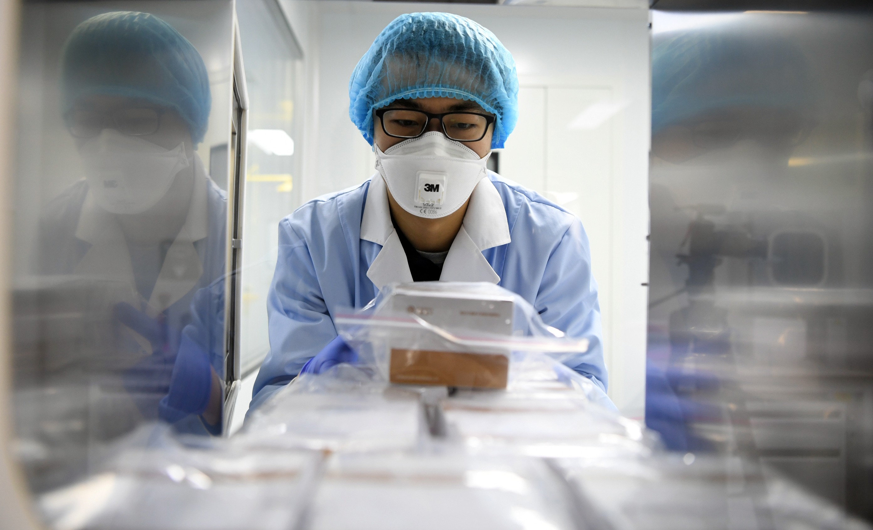 A researcher delivers detection reagents for the new coronavirus at a company in Tianjin, China. Photo: Xinhua