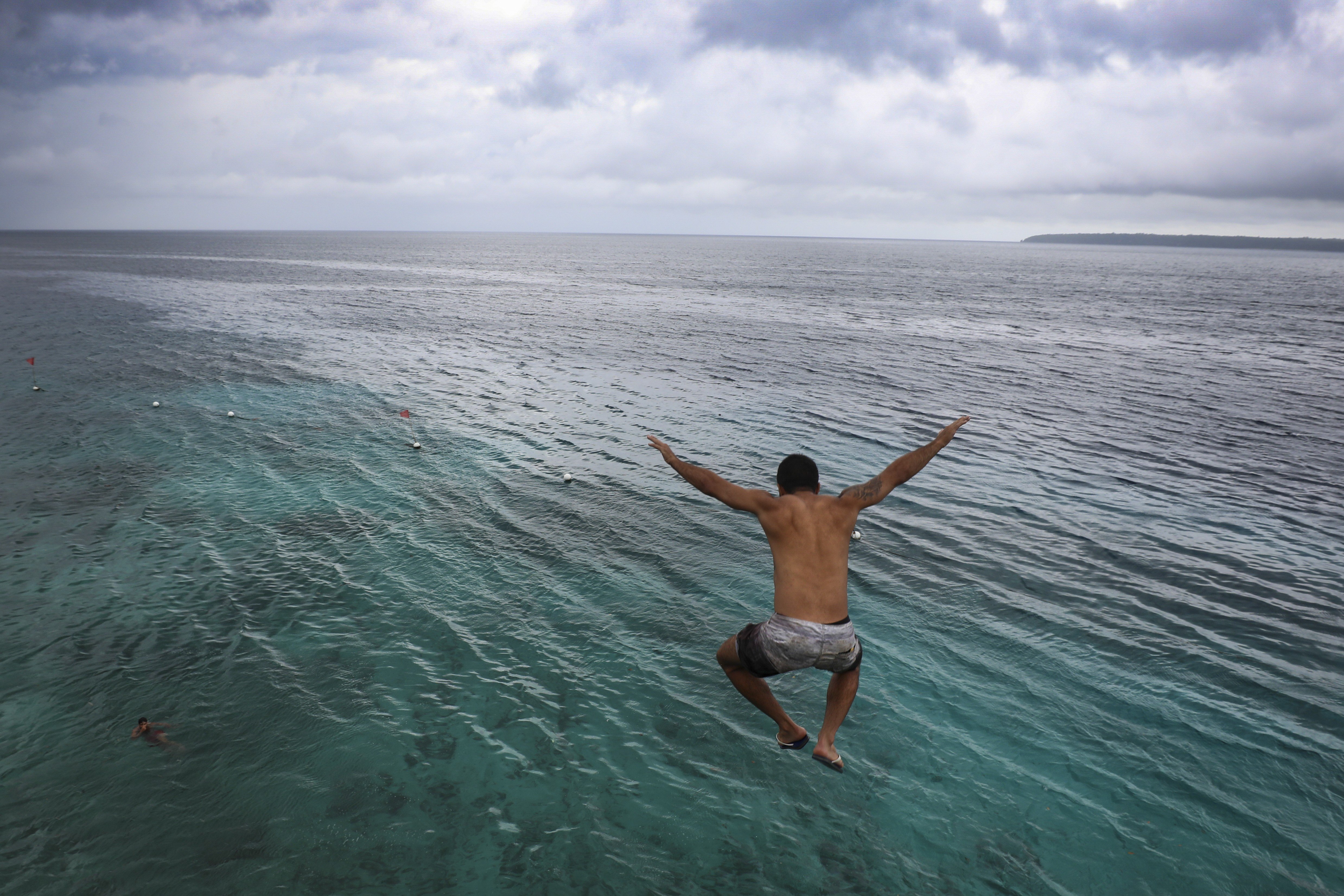 A tourist jumps from a cliff on Salagdoong beach in Siquijor. Photo: James Wendlinger