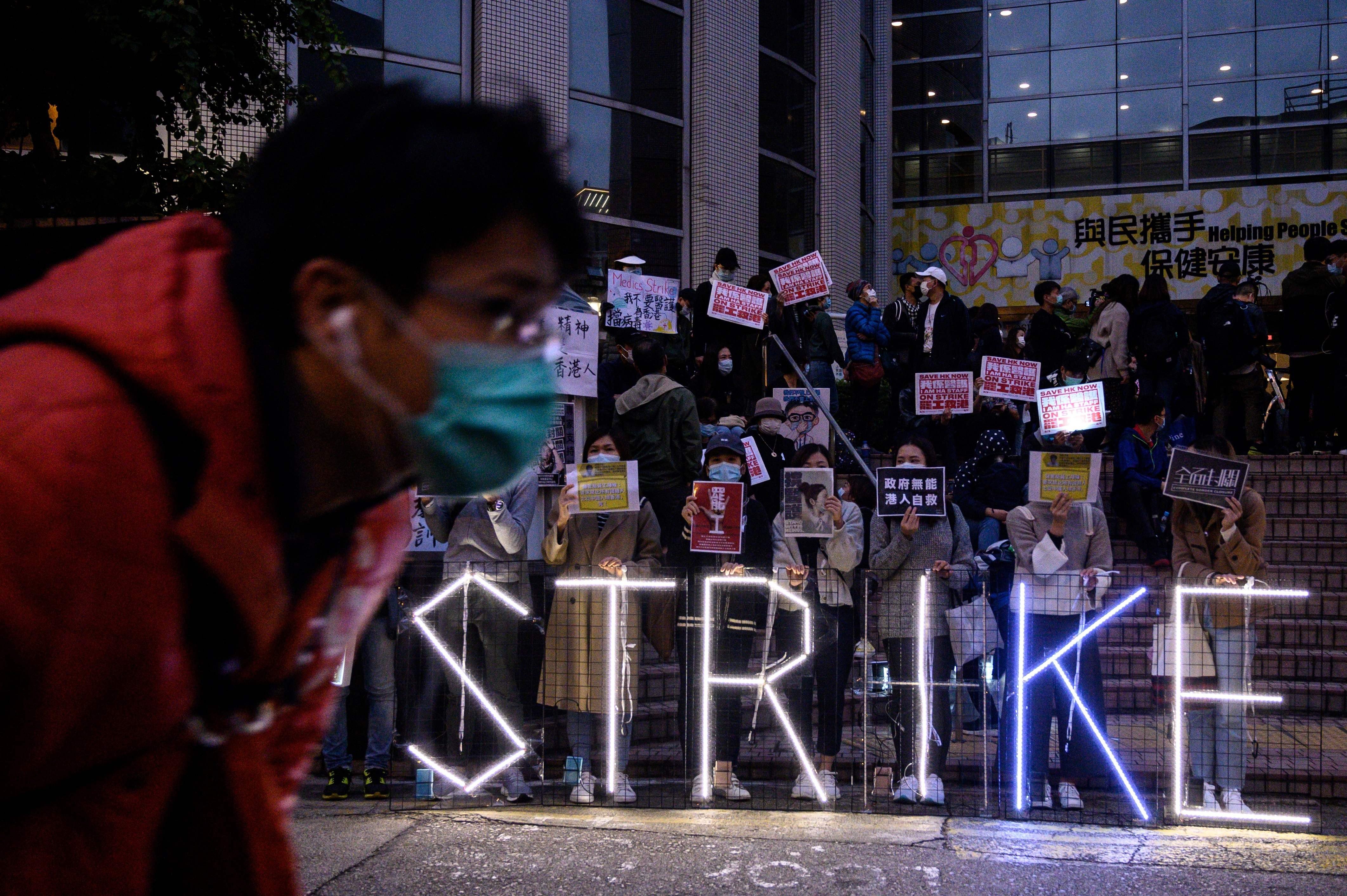 Striking members of the Hospital Authority Employees Alliance and other activists gather at the Hospital Authority building on February 7, calling for the closing of Hong Kong’s border with the mainland. Photo: AFP