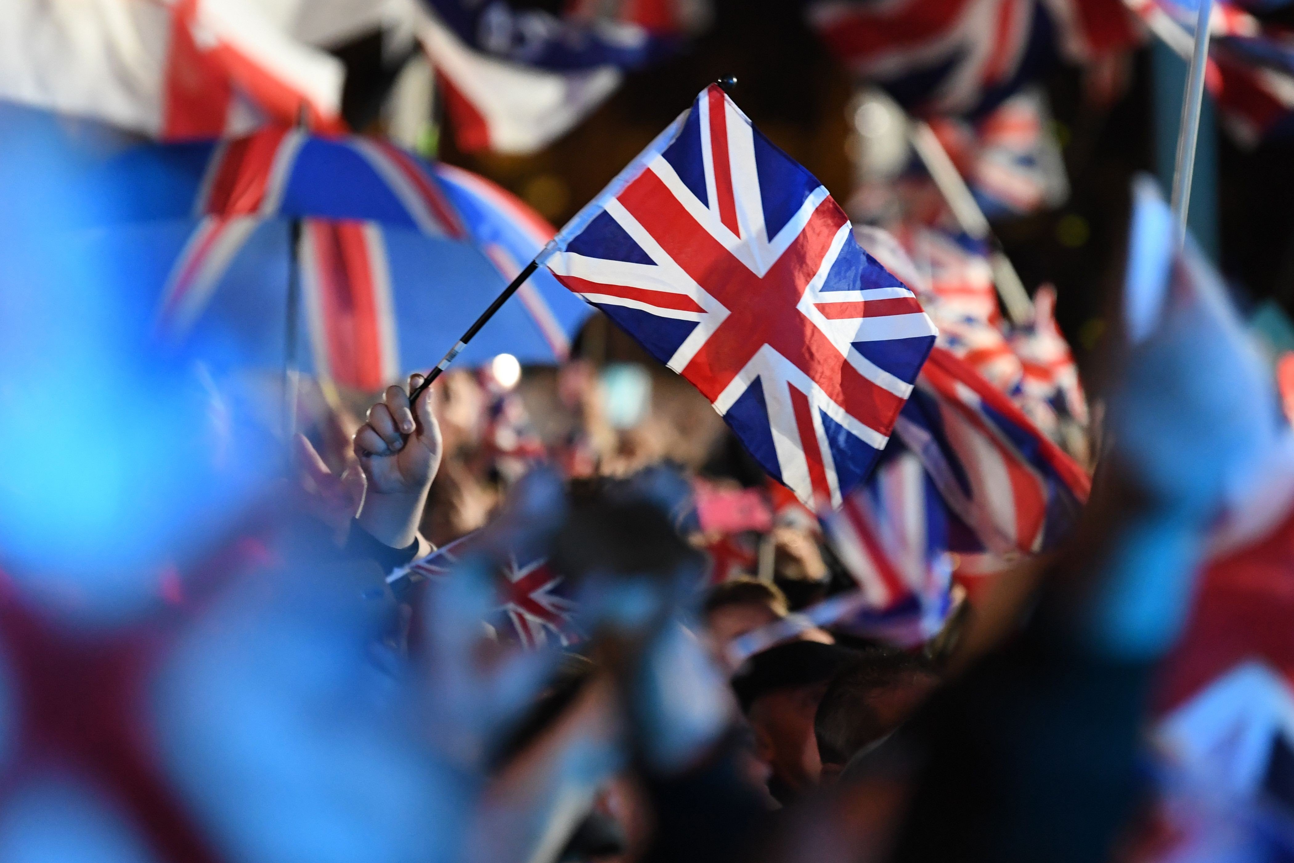 Brexit supporters wave Union flags in Parliament Square, London. Photo: AFP