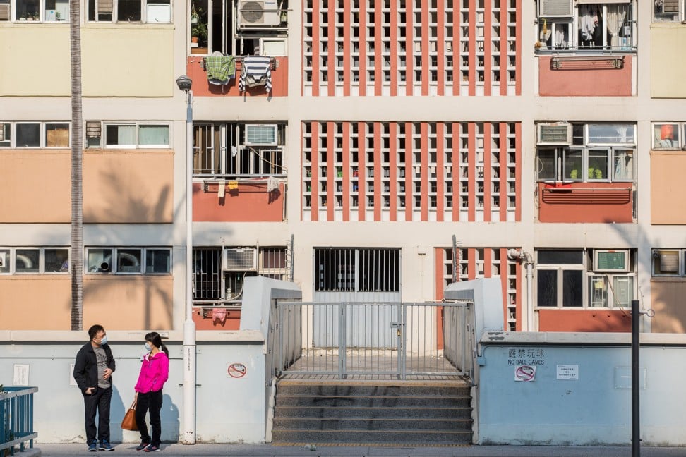 Two residents of a public housing estate in Hong Kong stop to chat on January 29. As free-market Hong Kong has shown, widening income inequalities cannot be narrowed without a collective will to act. Photo: Bloomberg