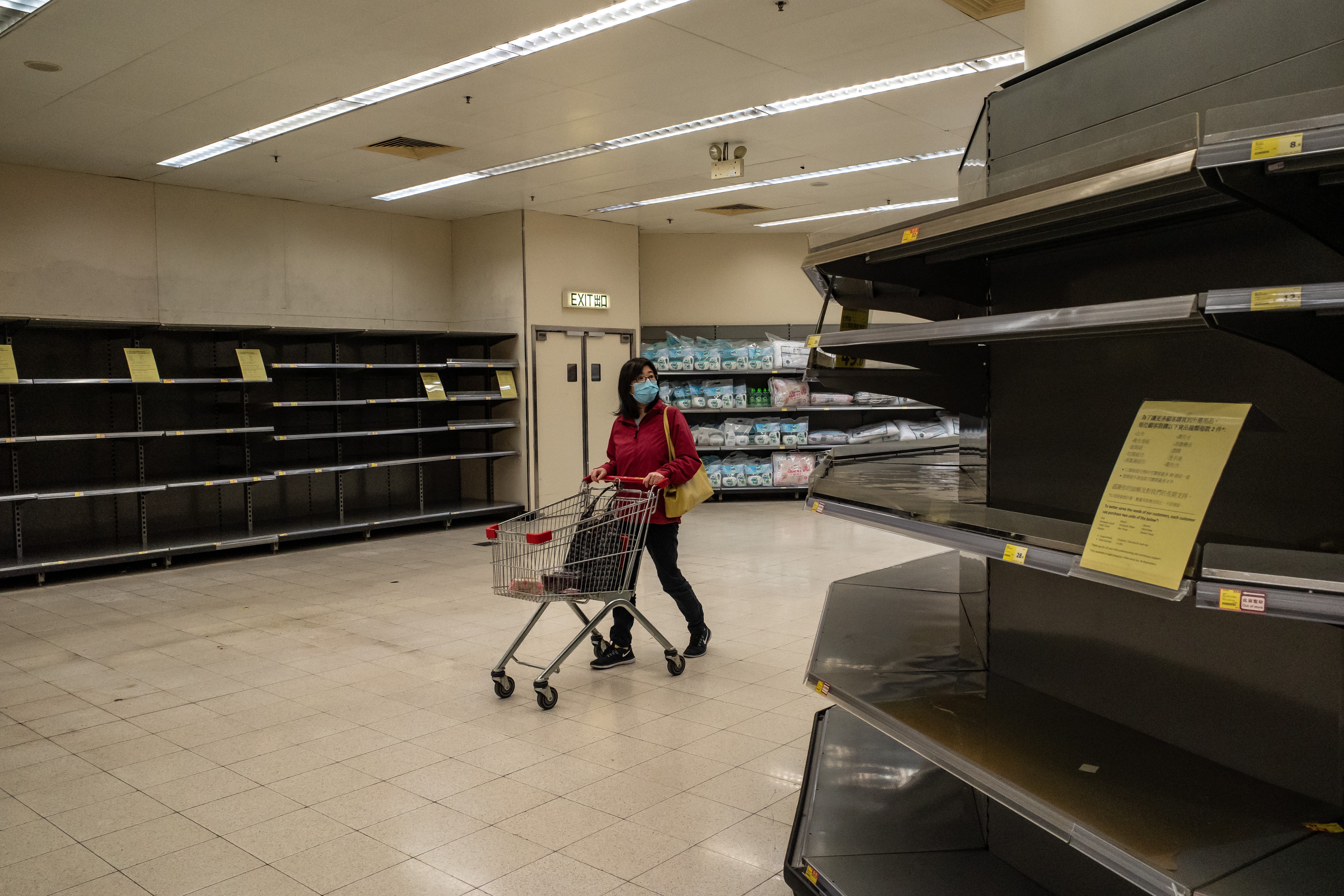 A shopper wearing a face mask pushes a shopping trolley past empty shelves inside a store in Hong Kong earlier this month. Photo: TNS