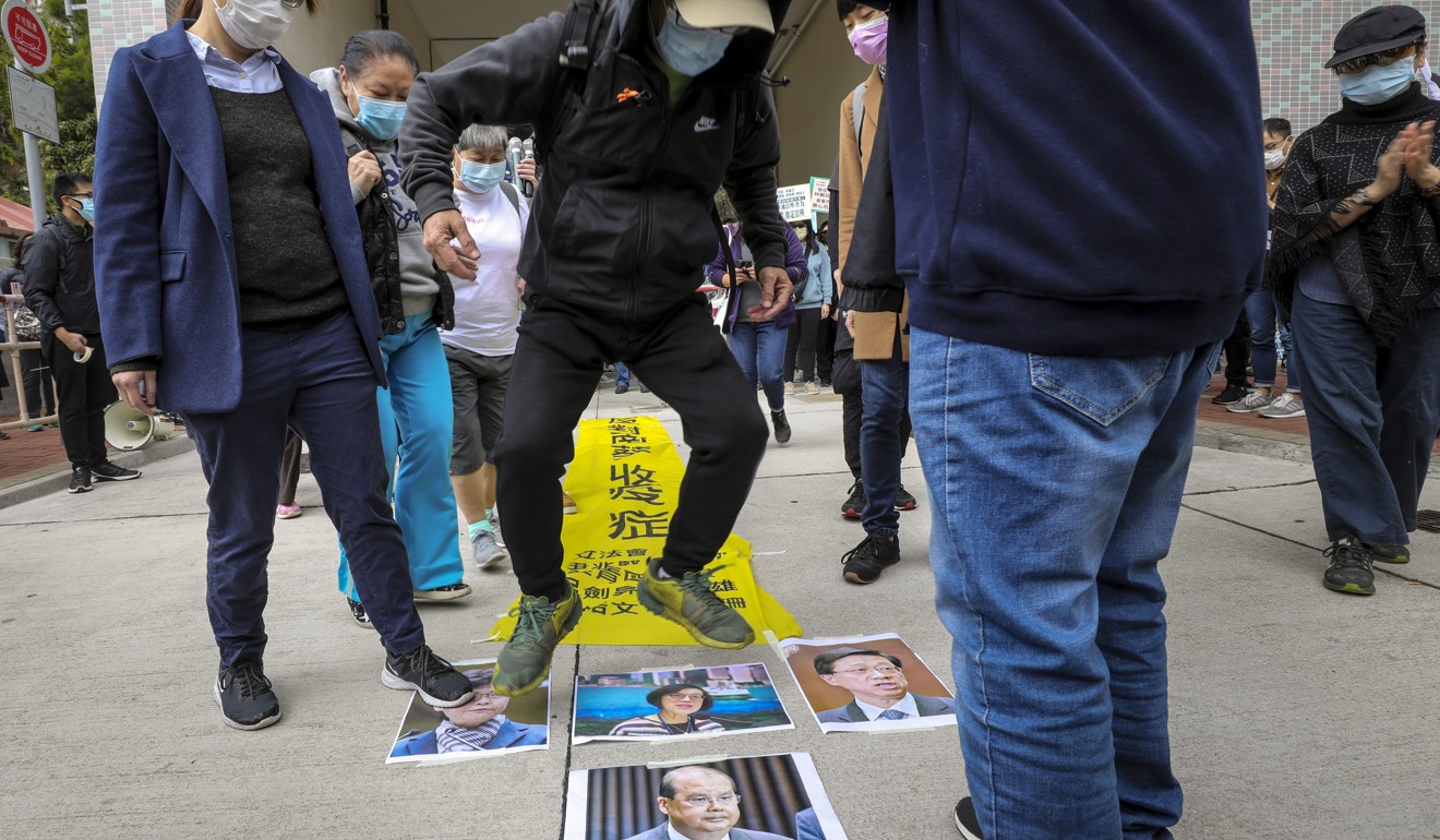 A protester steps on photos of officials to vent his anger. Photo: Dickson Lee