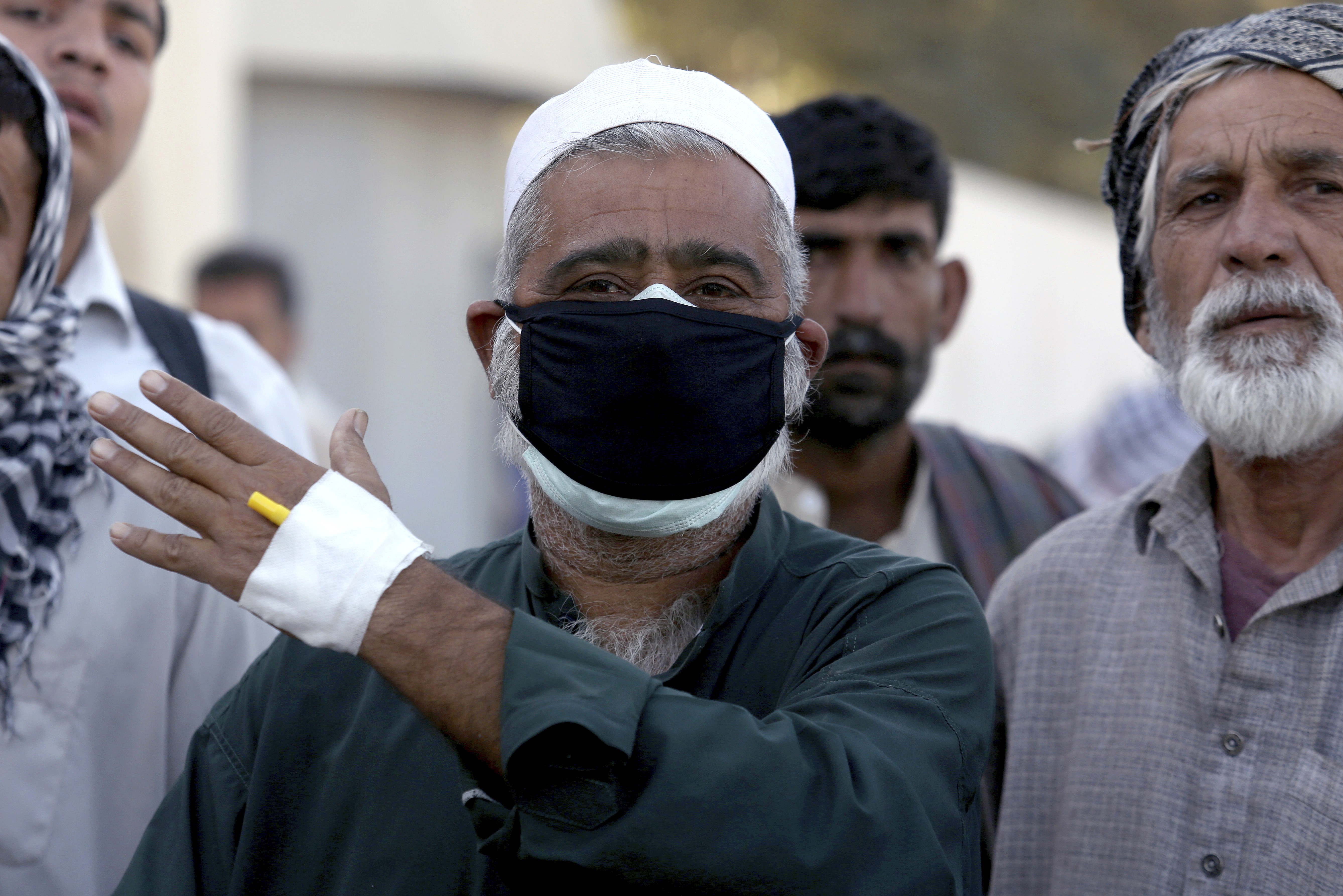 Keamari resident Sher Bahadur talks to media outside a hospital after receiving initial treatment following the toxic gas leak. Photo: AP