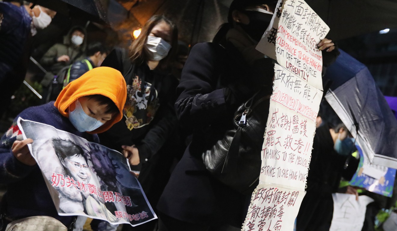Protesters gather in Fo Tan, as a boy holds a picture with words condemning Carrie Lam. Photo: Felix Wong