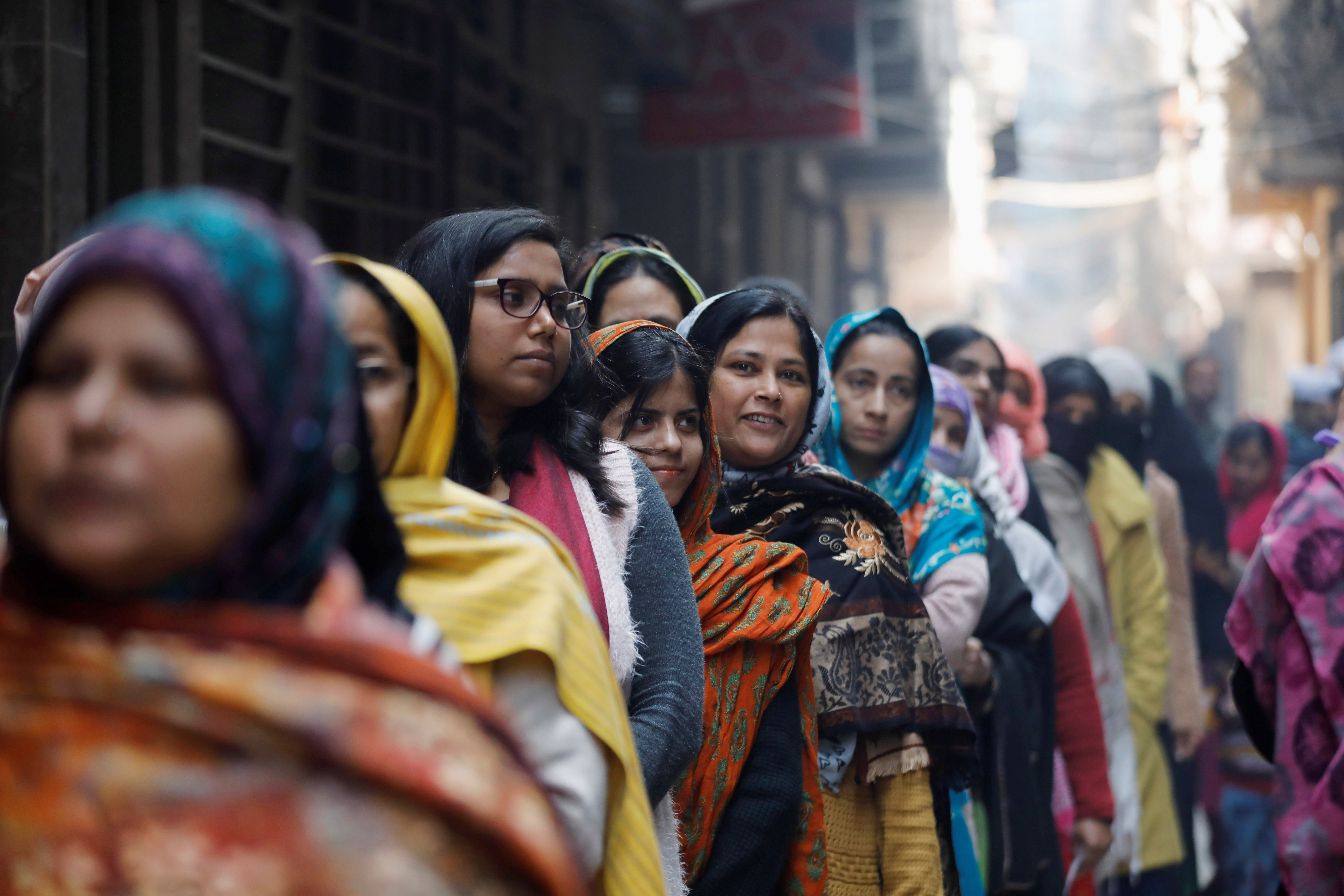 Women wait to cast their vote outside a polling booth during the state assembly election, in Shaheen Bagh, New Delhi, on February 8. Photo: Reuters