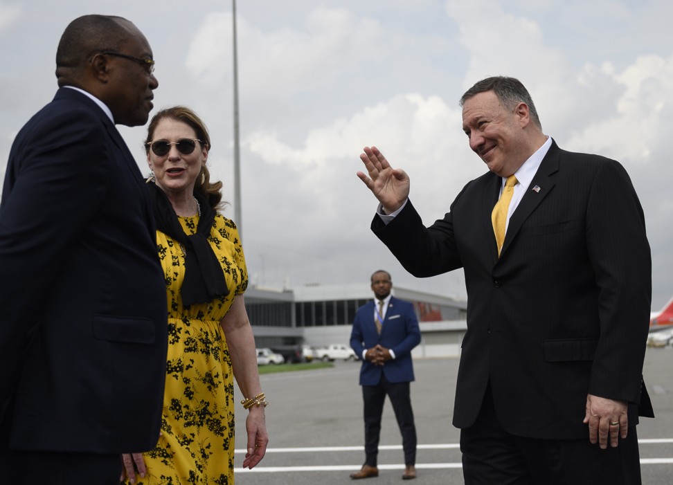 Mike Pompeo and his wife Susan greet Angola Foreign Minister Manuel Domingos Augusto in Luanda on Monday. Pool photo: AFP