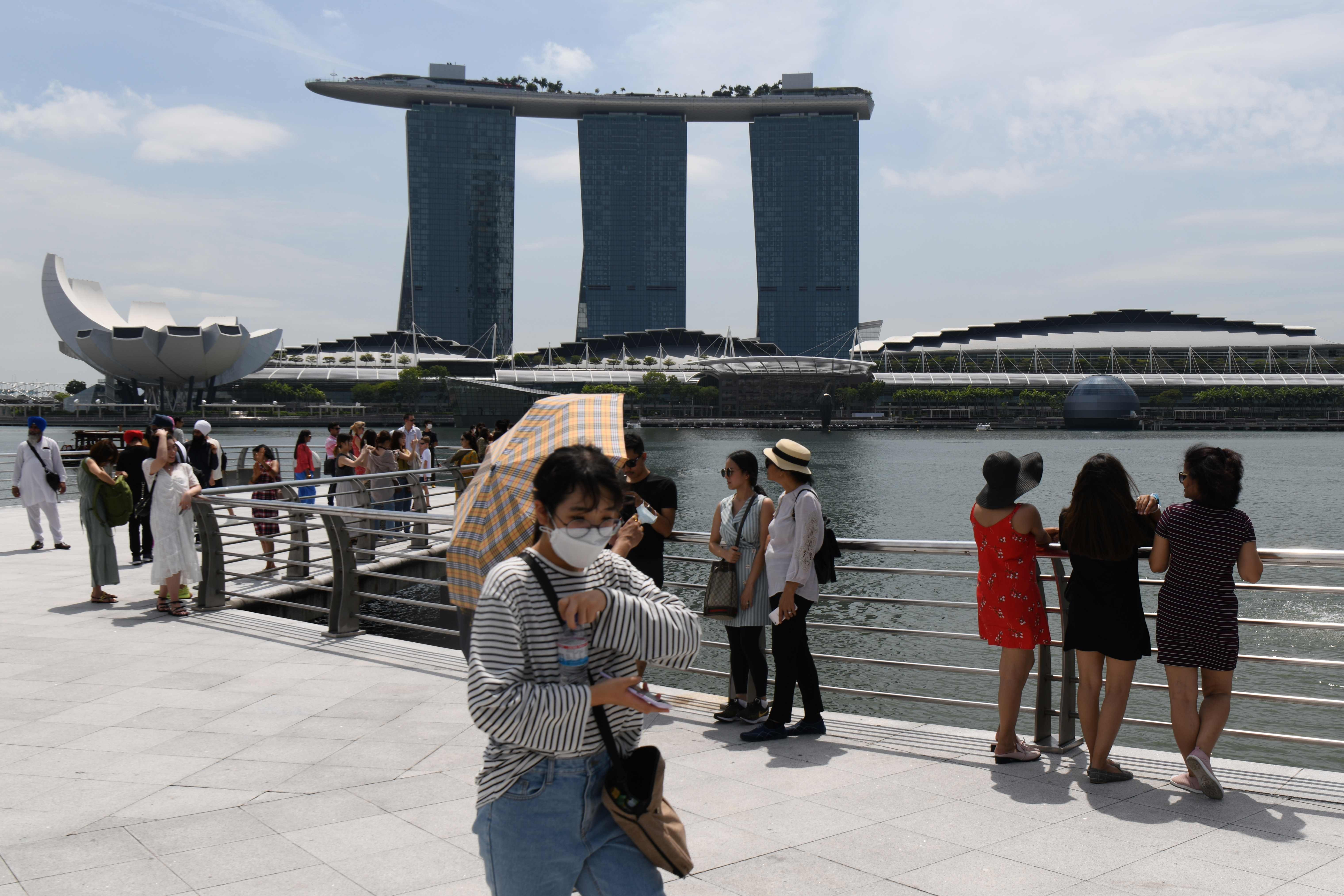 A visitor wearing a face mask amid coronavirus fears walks along Merlion Park in Singapore. Photo: AFP