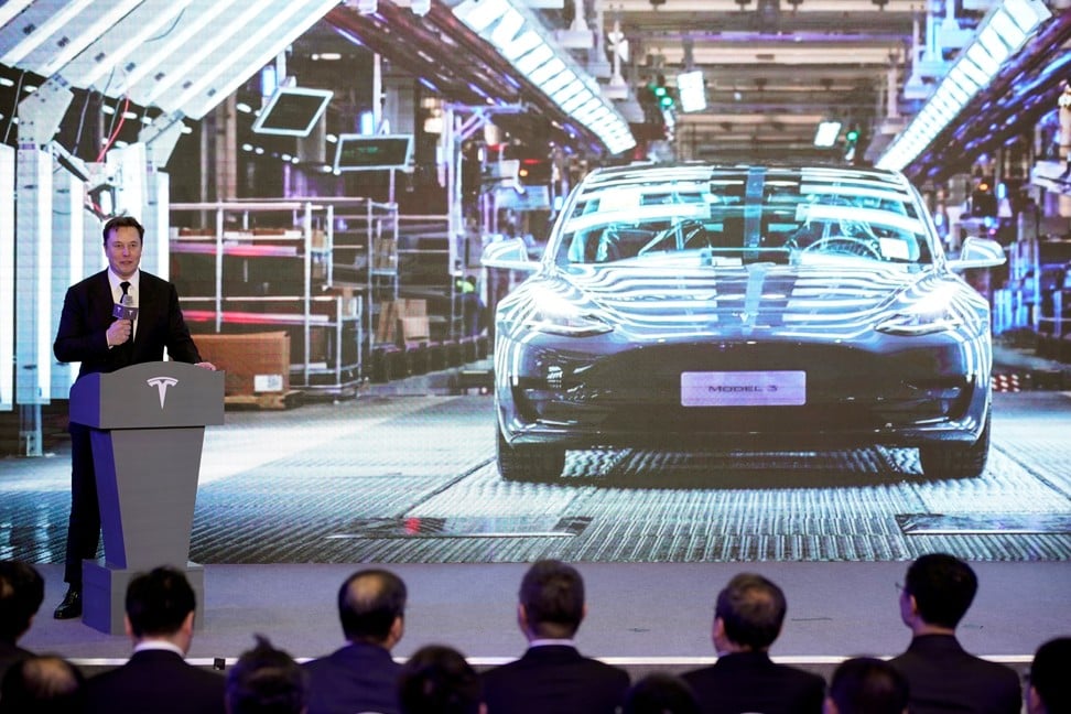 Tesla chief executive Elon Musk speaks next to a screen showing an image of the company’s Model 3 electric car at an event in Shanghai on January 7. Photo: Reuters