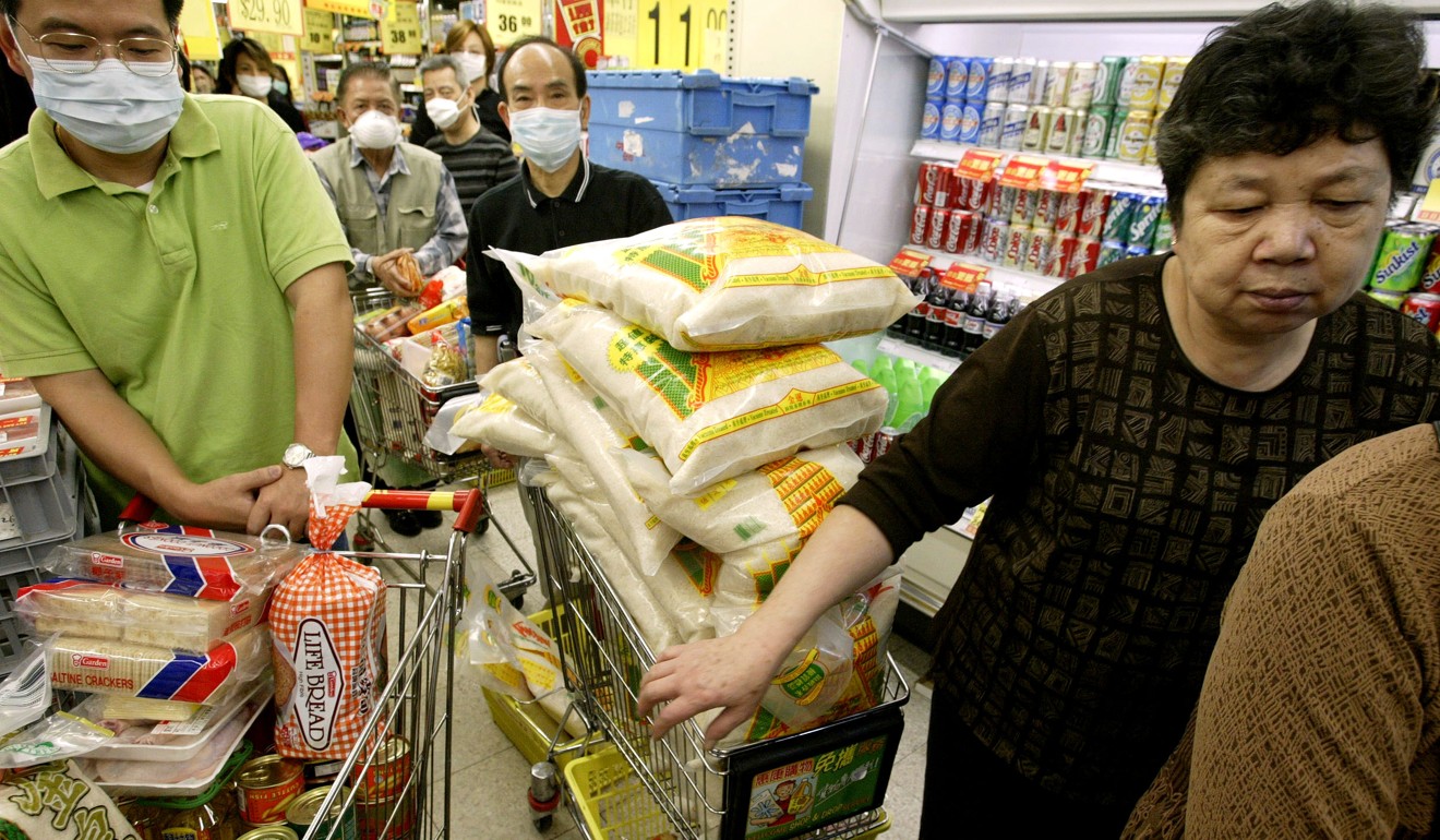 Shoppers stock up at a Wellcome store in Quarry Bay in April 2003, during the Sars outbreak. Panic buying lasted barely one day. Photo: SCMP