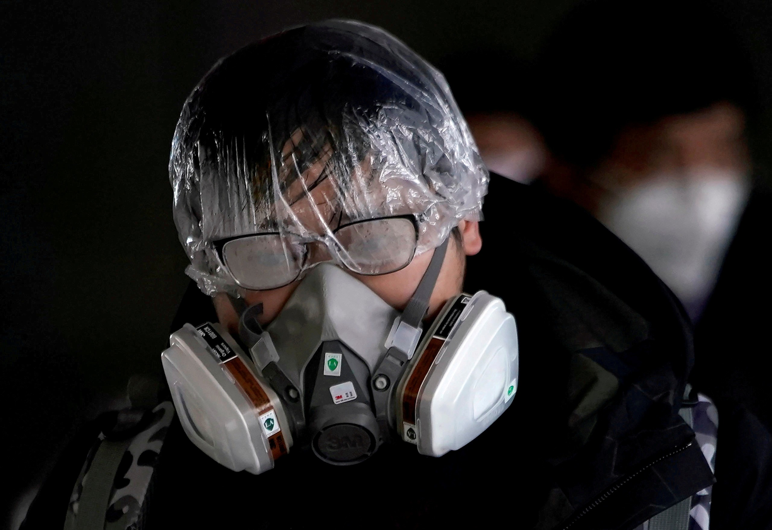 A man outside the Shanghai railway station wears a mask and other protective gear. Photo: Reuters