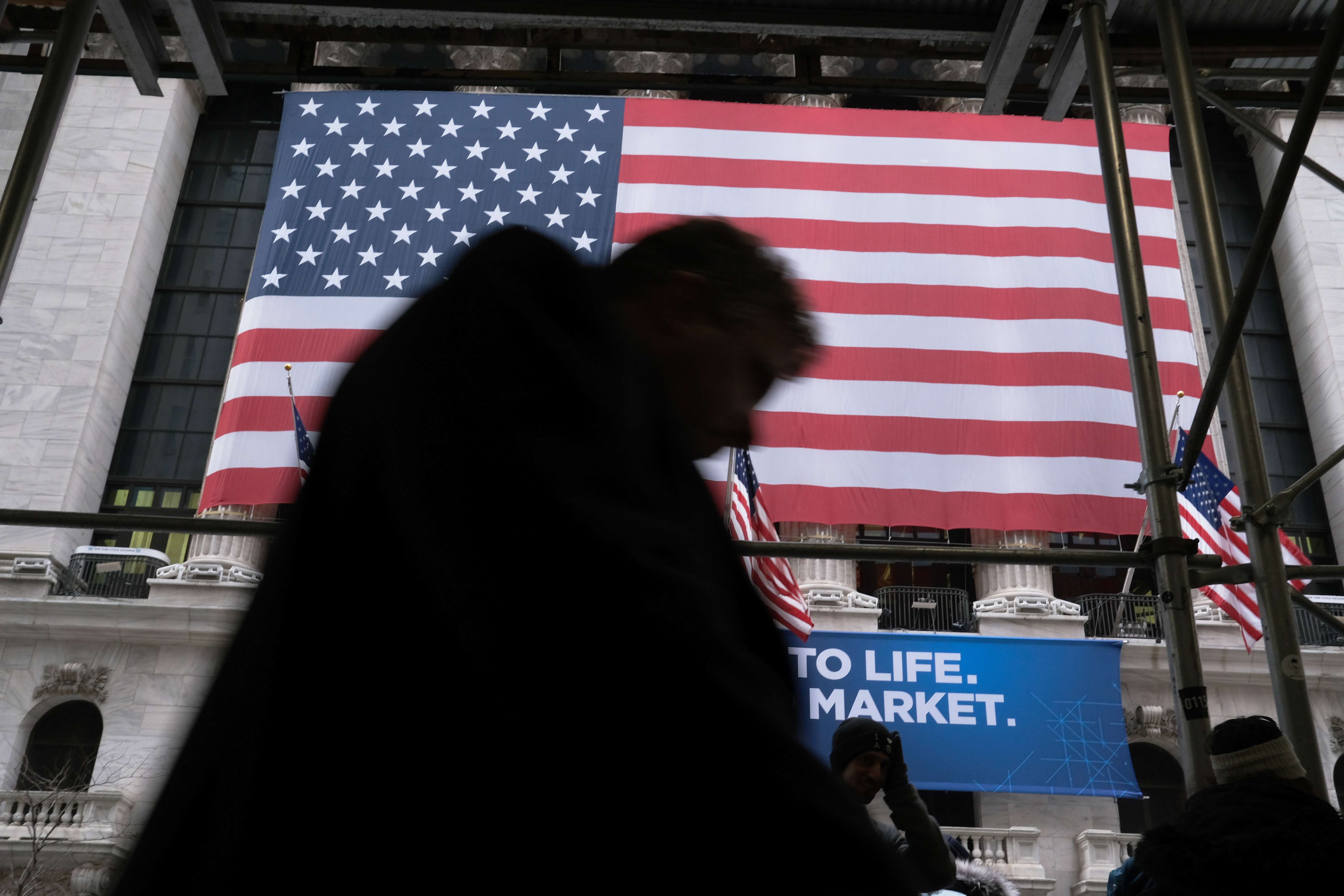 People walk past the New York Stock Exchange on February 12. US stocks have rallied to an all-time high this month despite worries over sluggish economies in China and Europe and the coronavirus outbreak. Photo: Getty Images / AFP