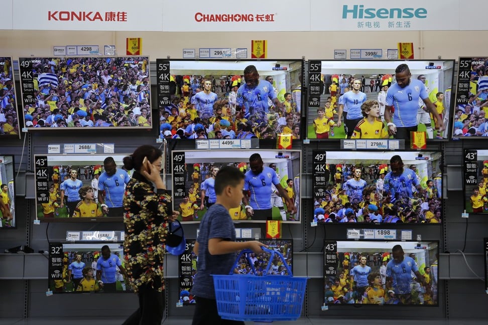 Chinese producers of flat-screen televisions on display at a hypermarket in Beijing on Wednesday, July 11, 2018. Photo: AP
